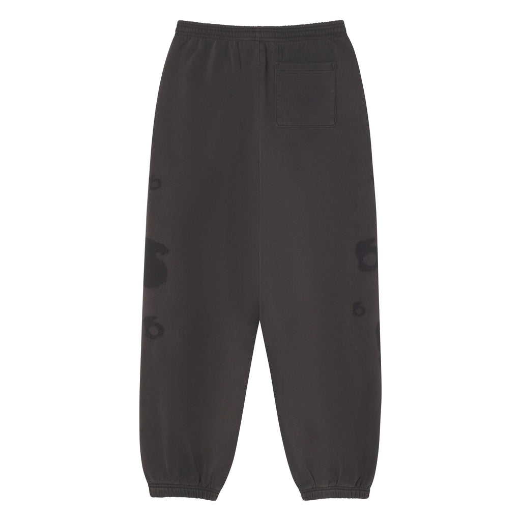 Grey 100% cotton fleece sweatpants with elasticized waistband, cuffs, and distressed graphic print designs.