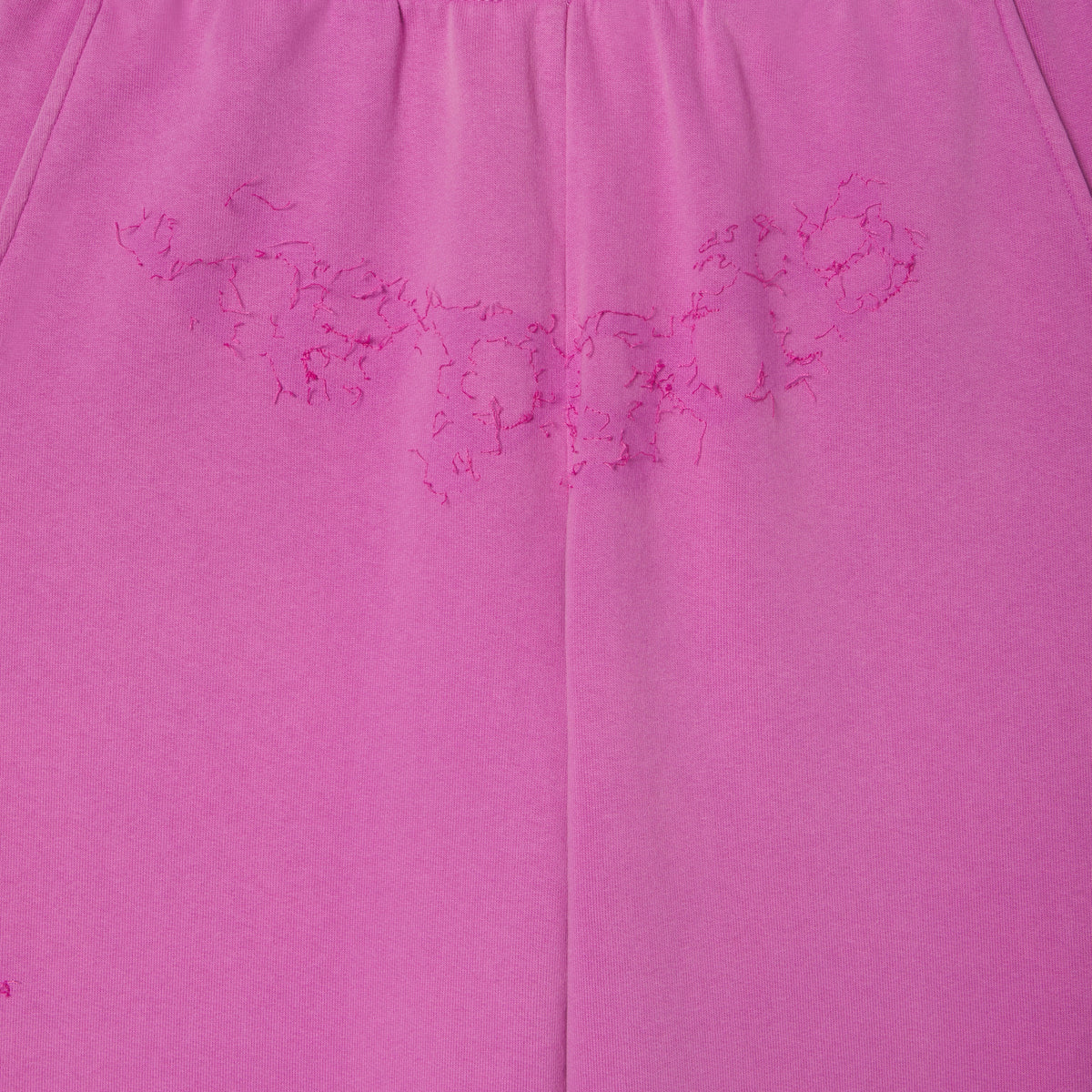 Pink 100% cotton fleece sweatpants featuring distressed SP5DER graphic print at the crotch.
