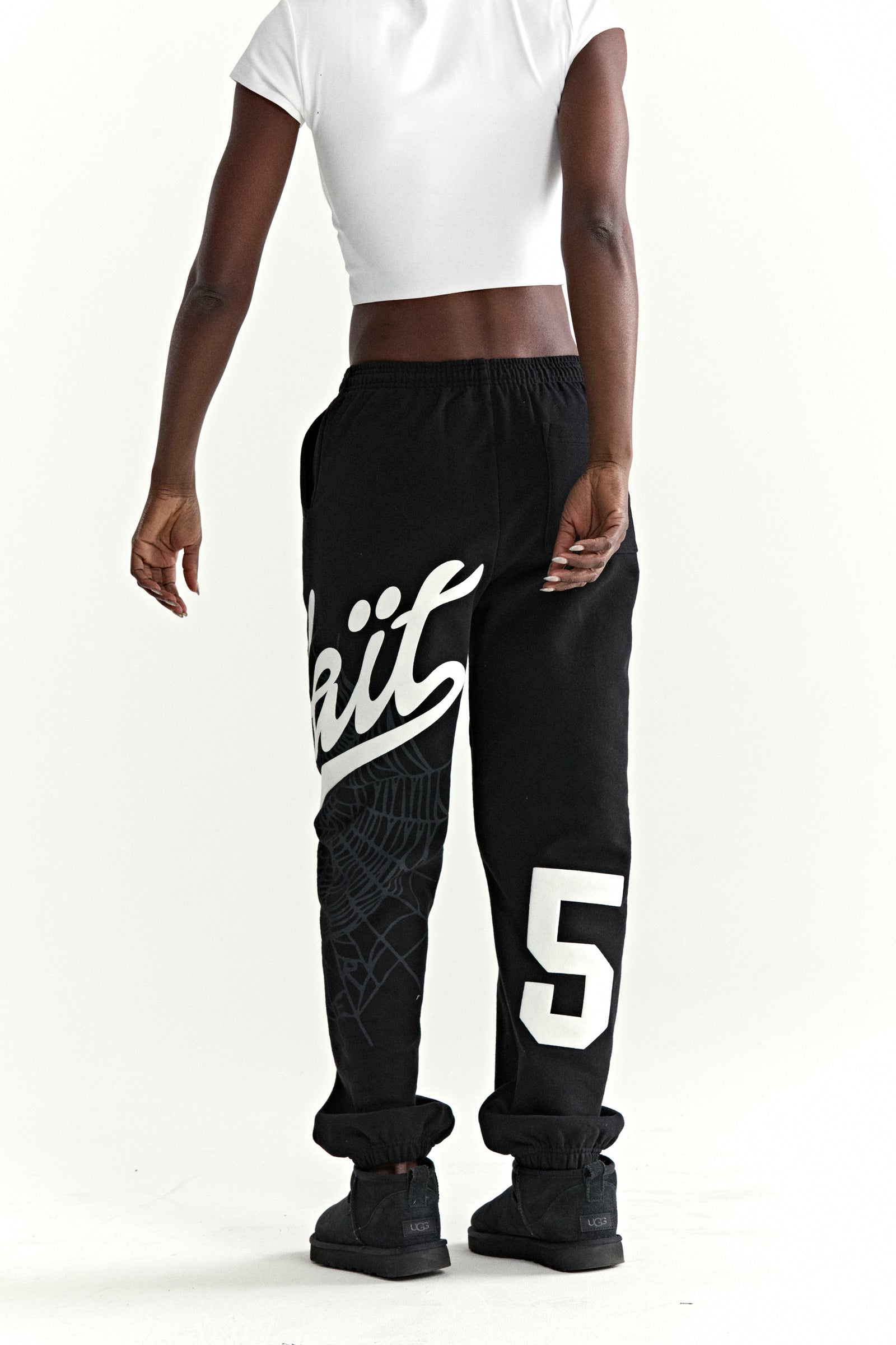 Black cotton fleece sweatpants with "Wait" script, web print, and large "5" motif.