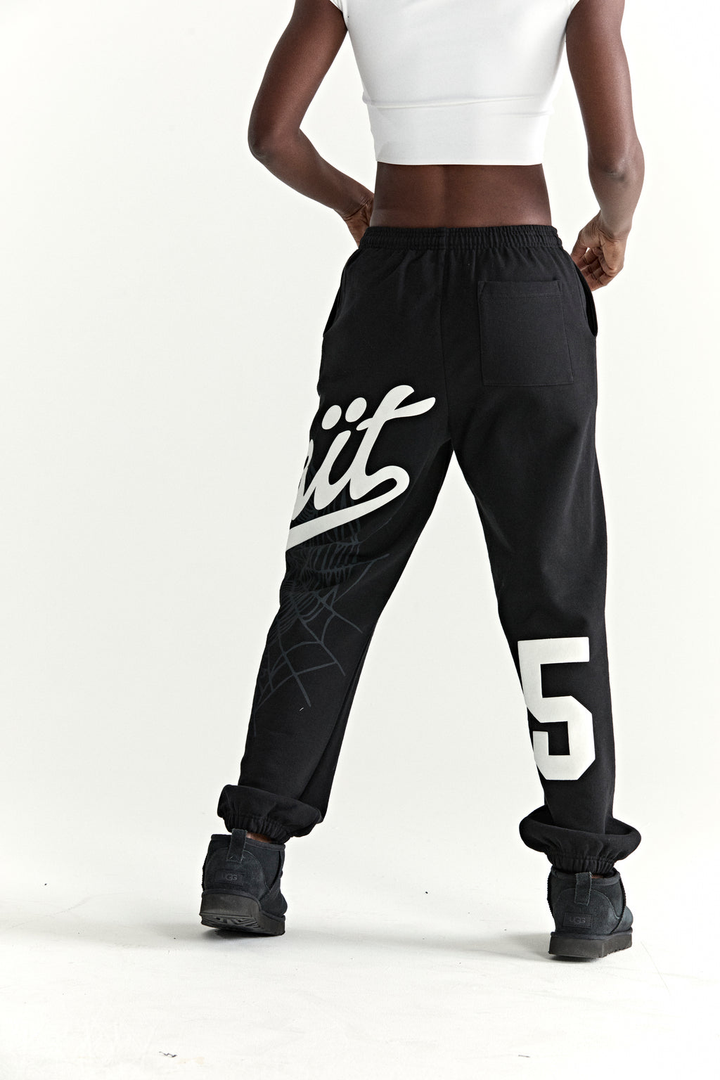 Black cotton fleece sweatpants with "Wait" script, spiderweb, and "5" prints.