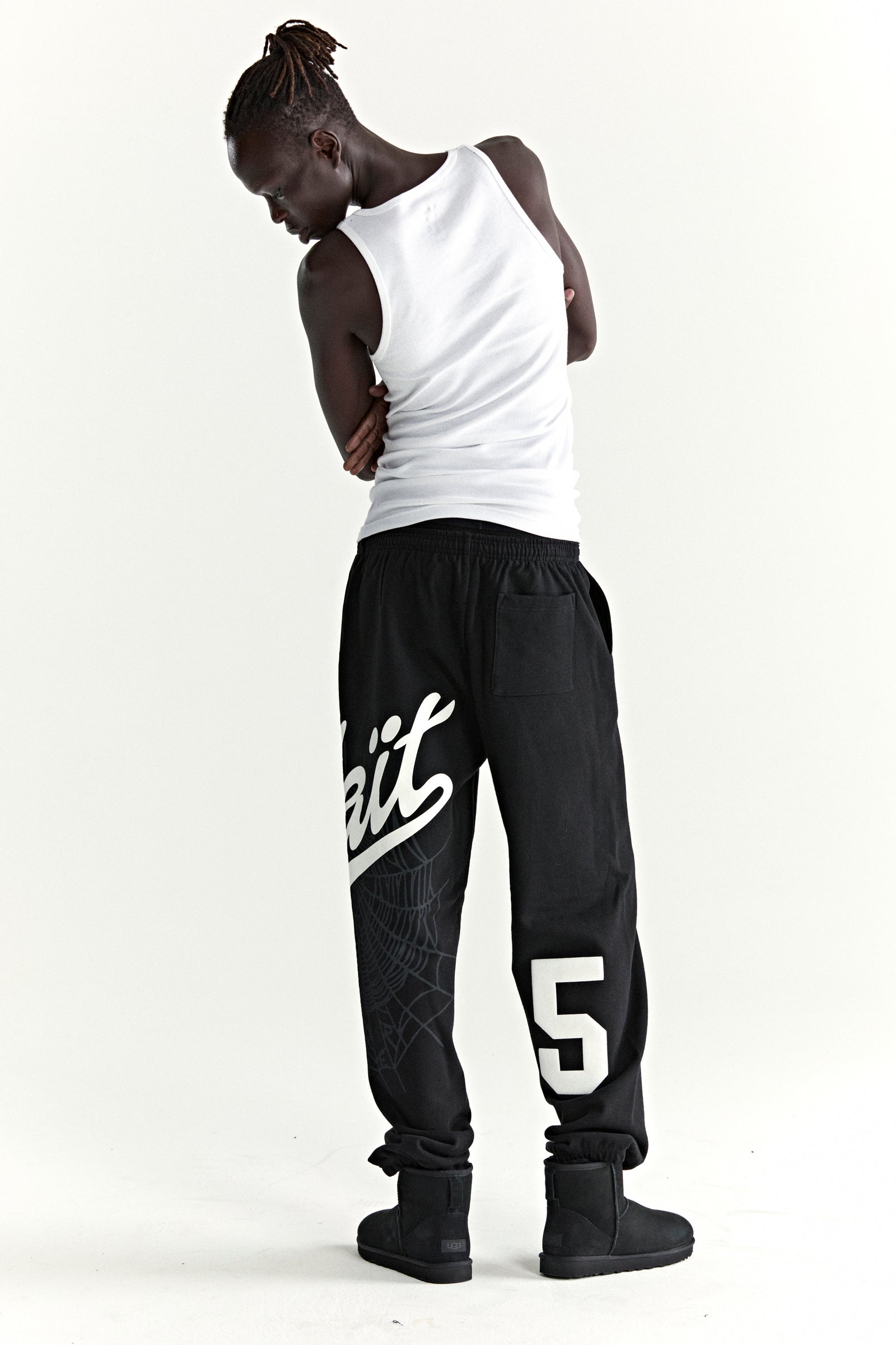 Black cotton fleece sweatpants with "Wait" script, web print, and large "5" motif.