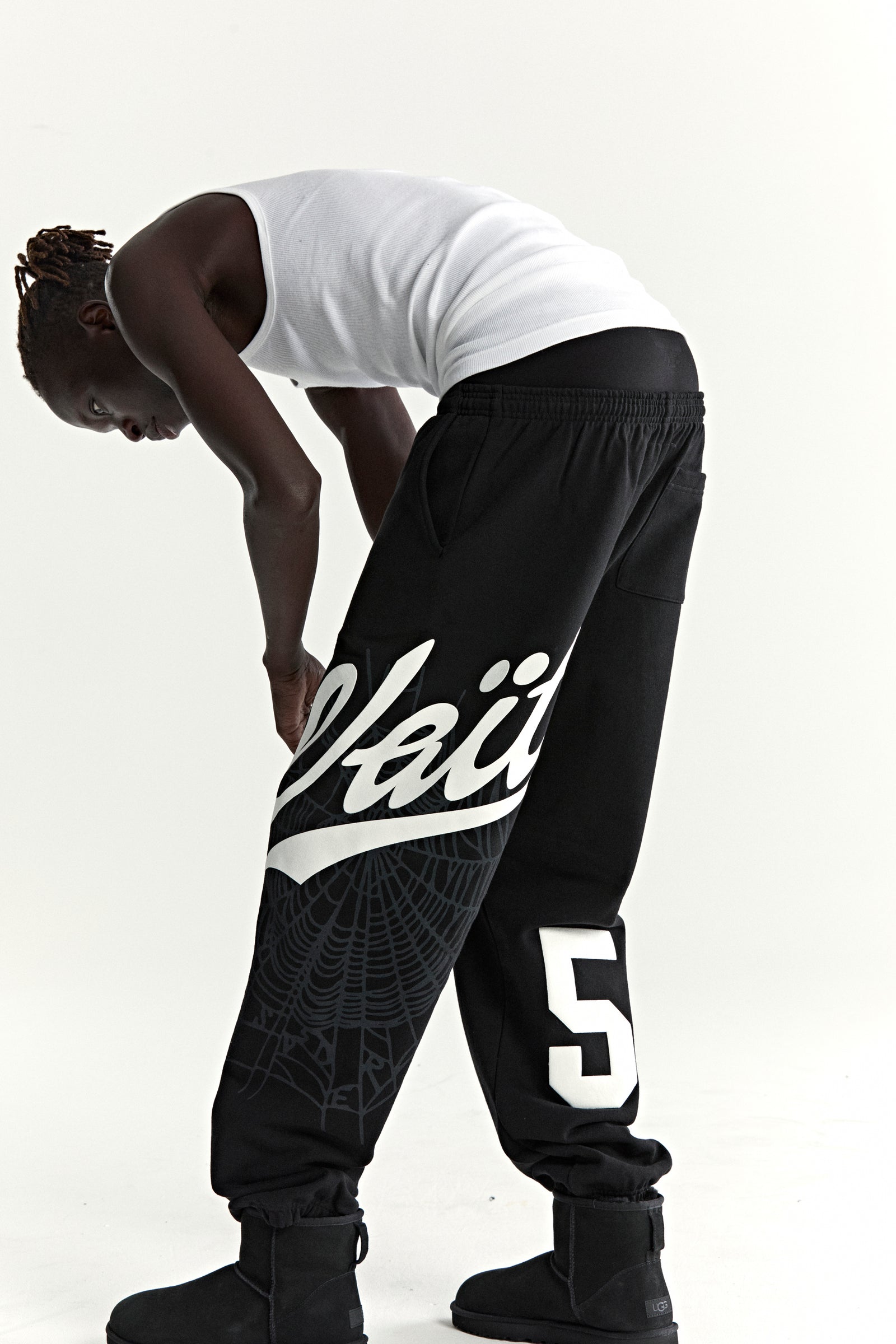 Black cotton fleece sweatpants with "Wait" script, spiderweb, and "5" prints.