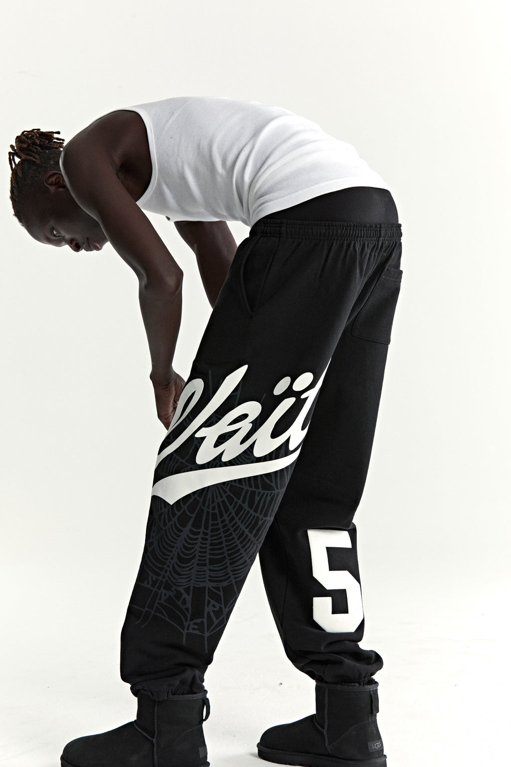 Black cotton fleece sweatpants with "Wait" script, spiderweb, and "5" prints.
