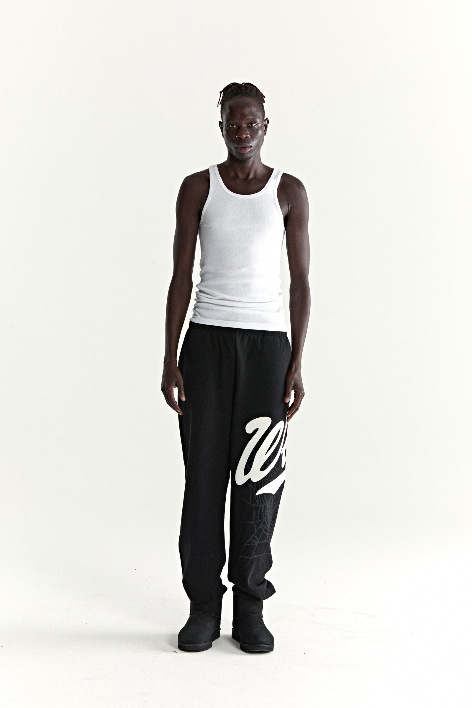 Black 13oz cotton fleece STADIUM SWEATPANT with white 'Wait' script and web print, elasticized cuffs.