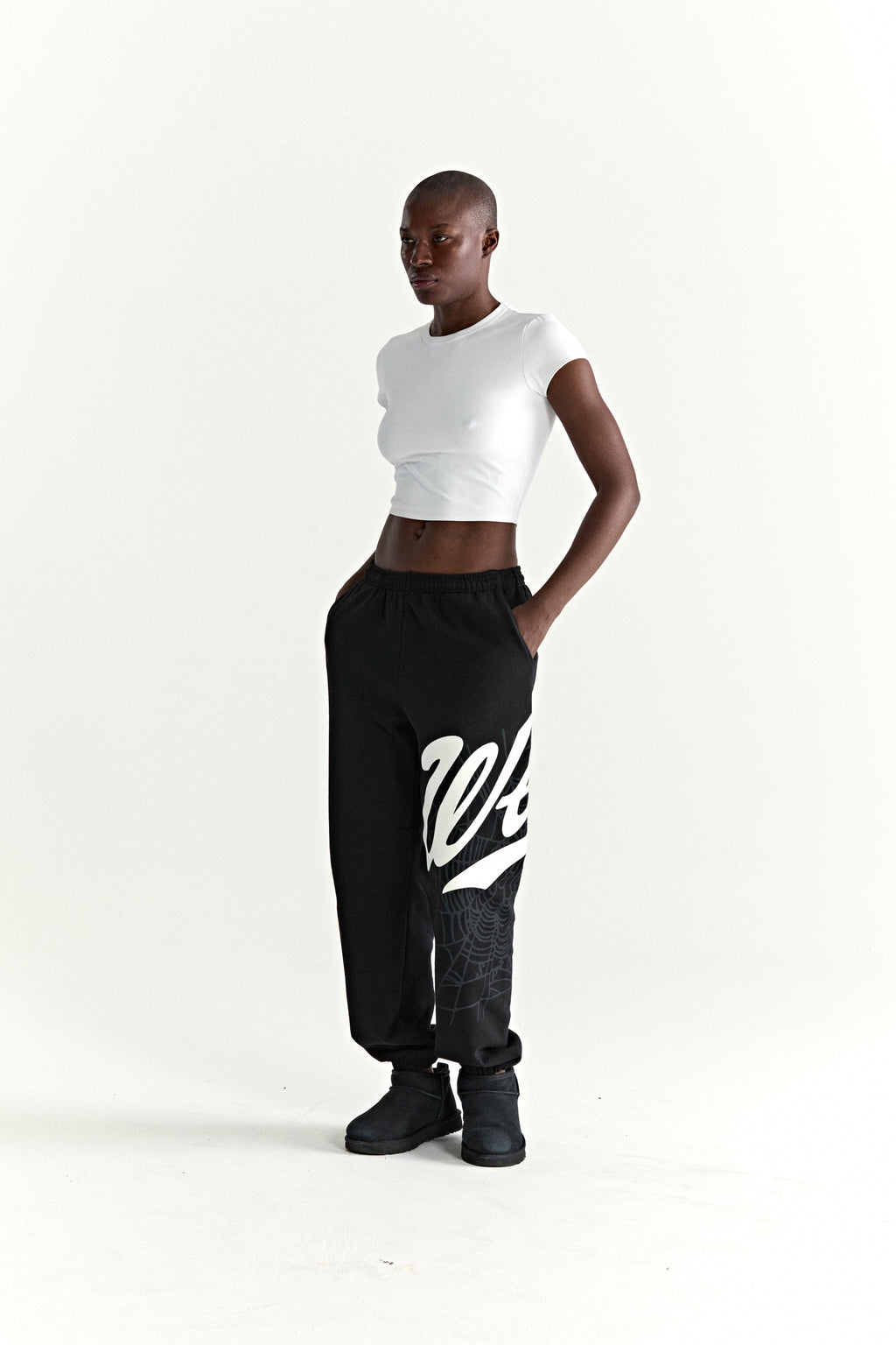 Black 13oz cotton fleece STADIUM SWEATPANT with white 'Wait' script and web print, elasticized cuffs.