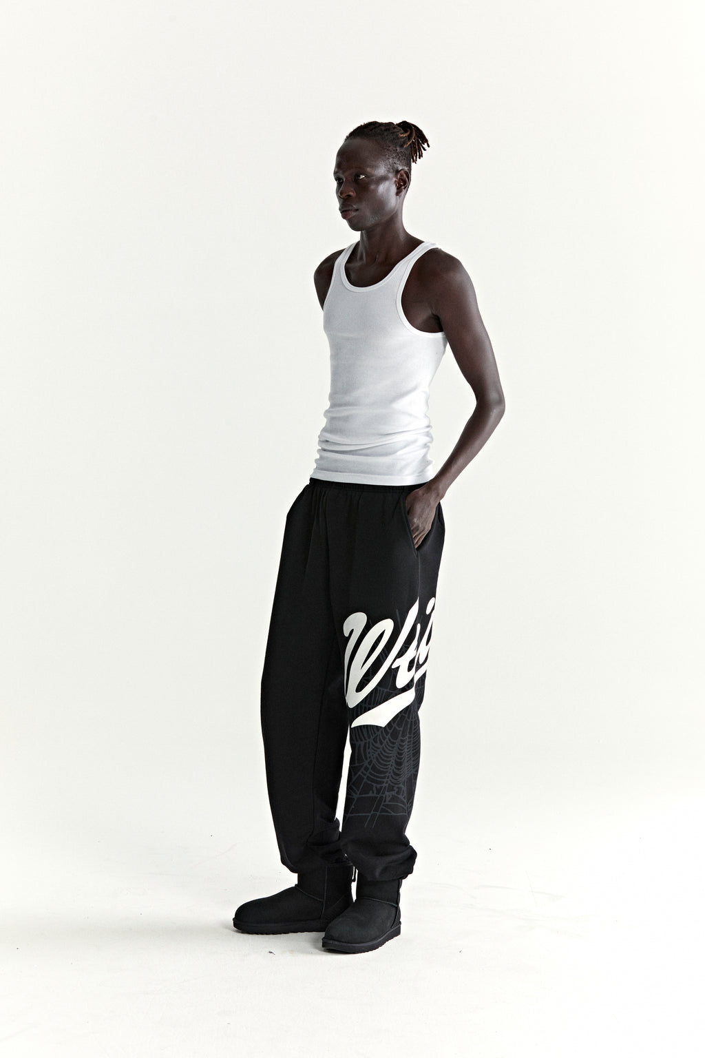 Black 13oz cotton fleece STADIUM SWEATPANT with white 'Wait' script, web, and '5' puff/discharge prints.