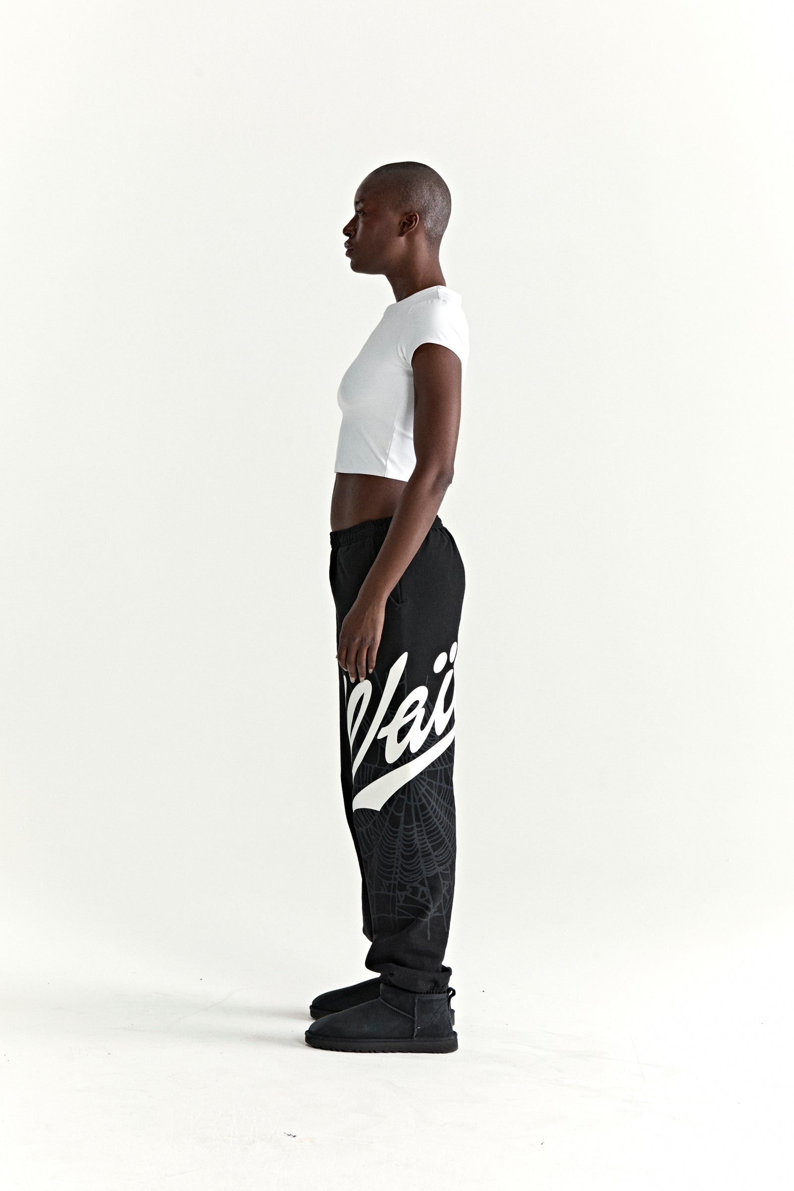 Black cotton fleece STADIUM SWEATPANT with white 'Wait' script and web print.