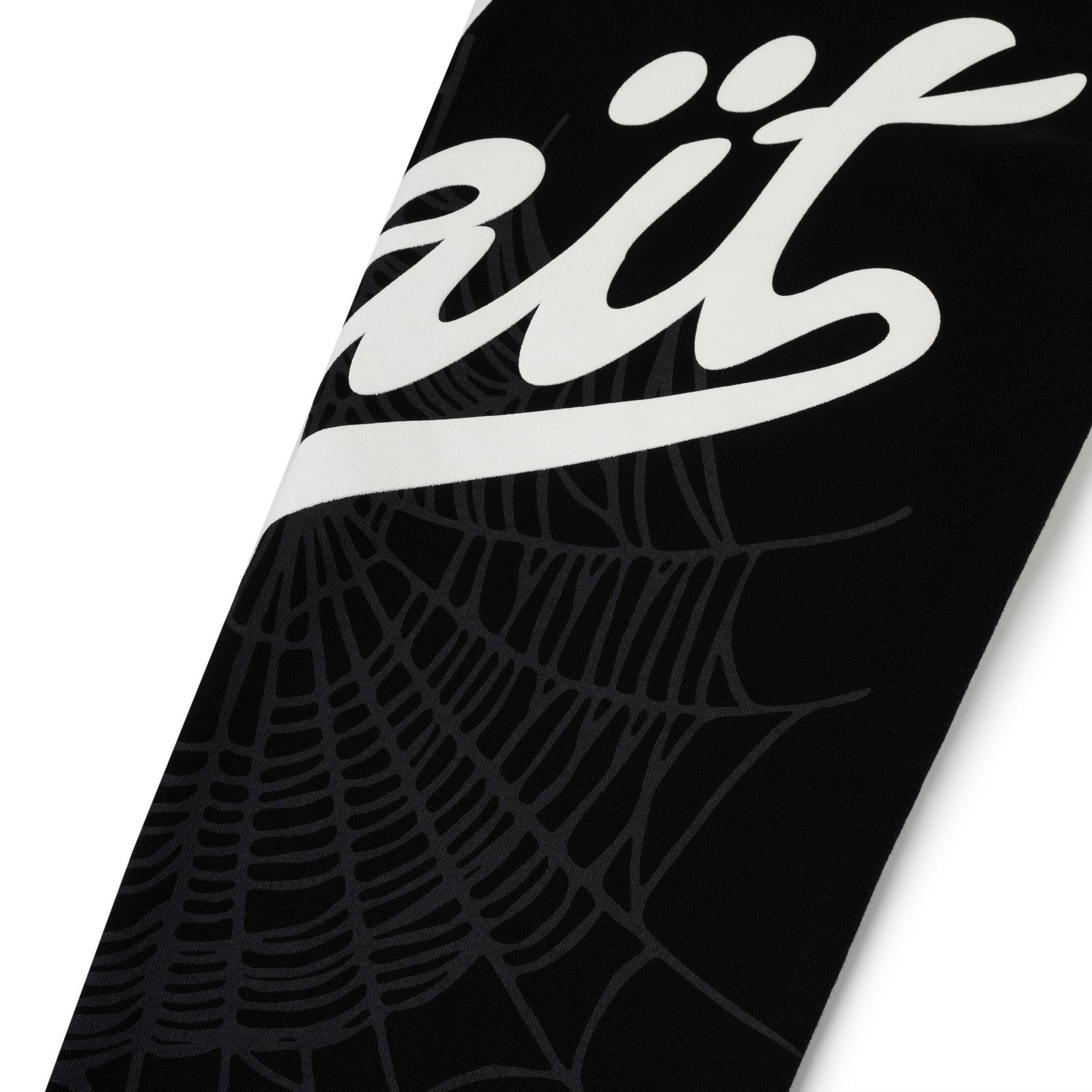 Black cotton fleece sweatpant with white "Wait" script and spiderweb print.