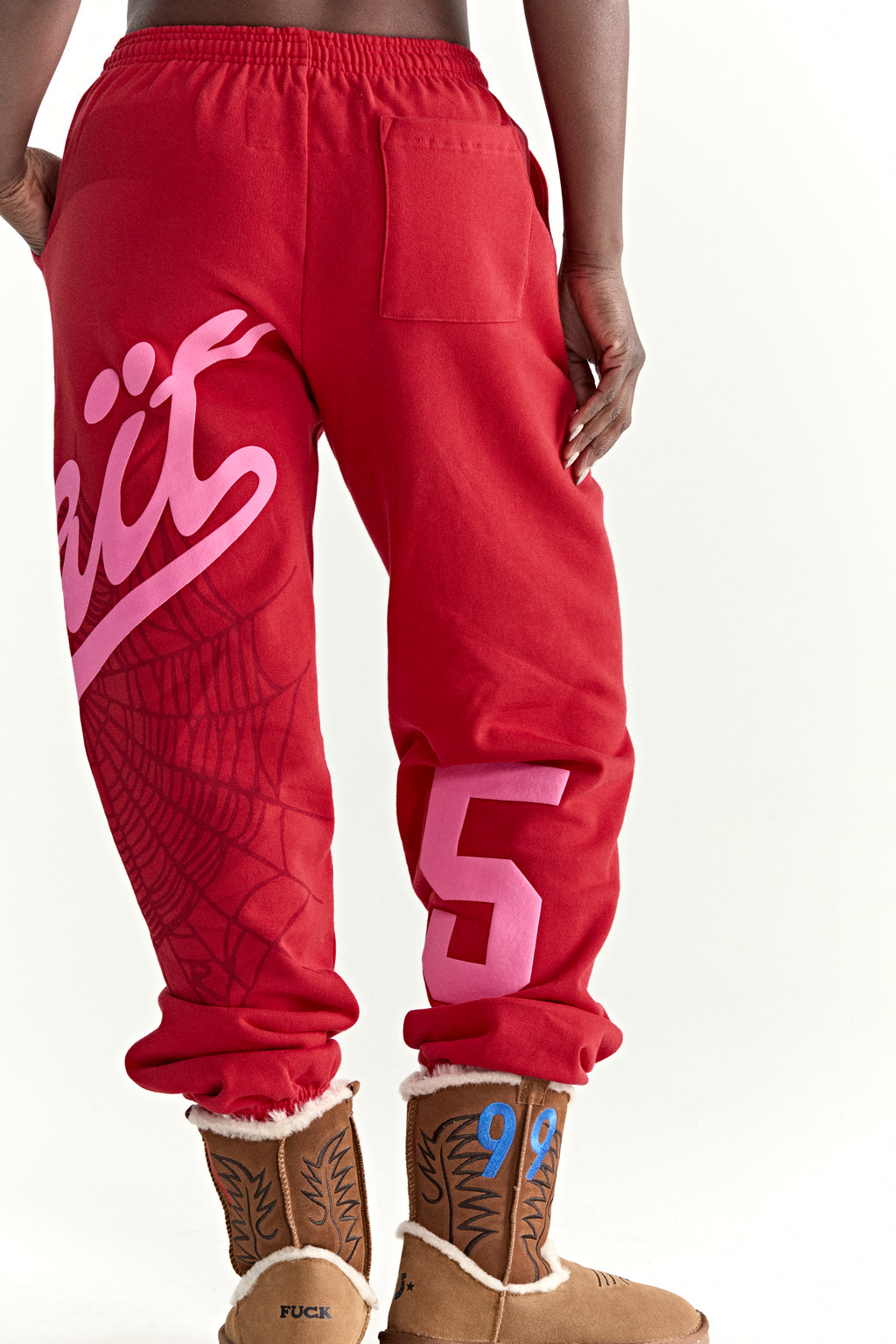 Red cotton fleece sweatpants with pink "Wait" script, spiderweb, and "5" prints.