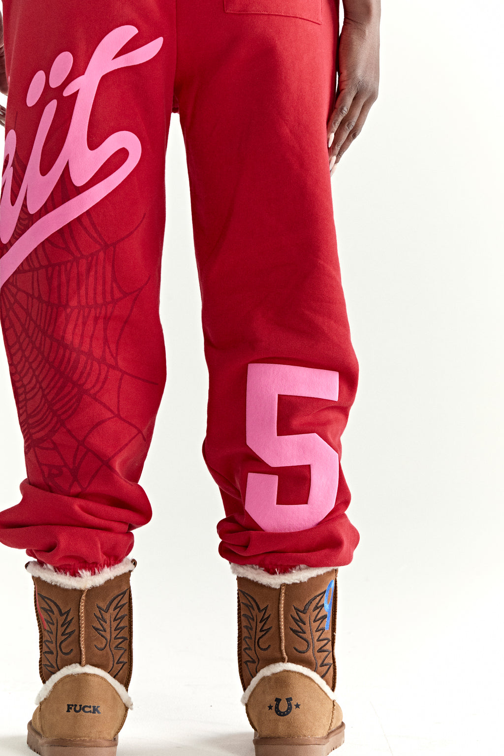 Red cotton fleece sweatpants with pink "Wait" script, spiderweb, and "5" prints.