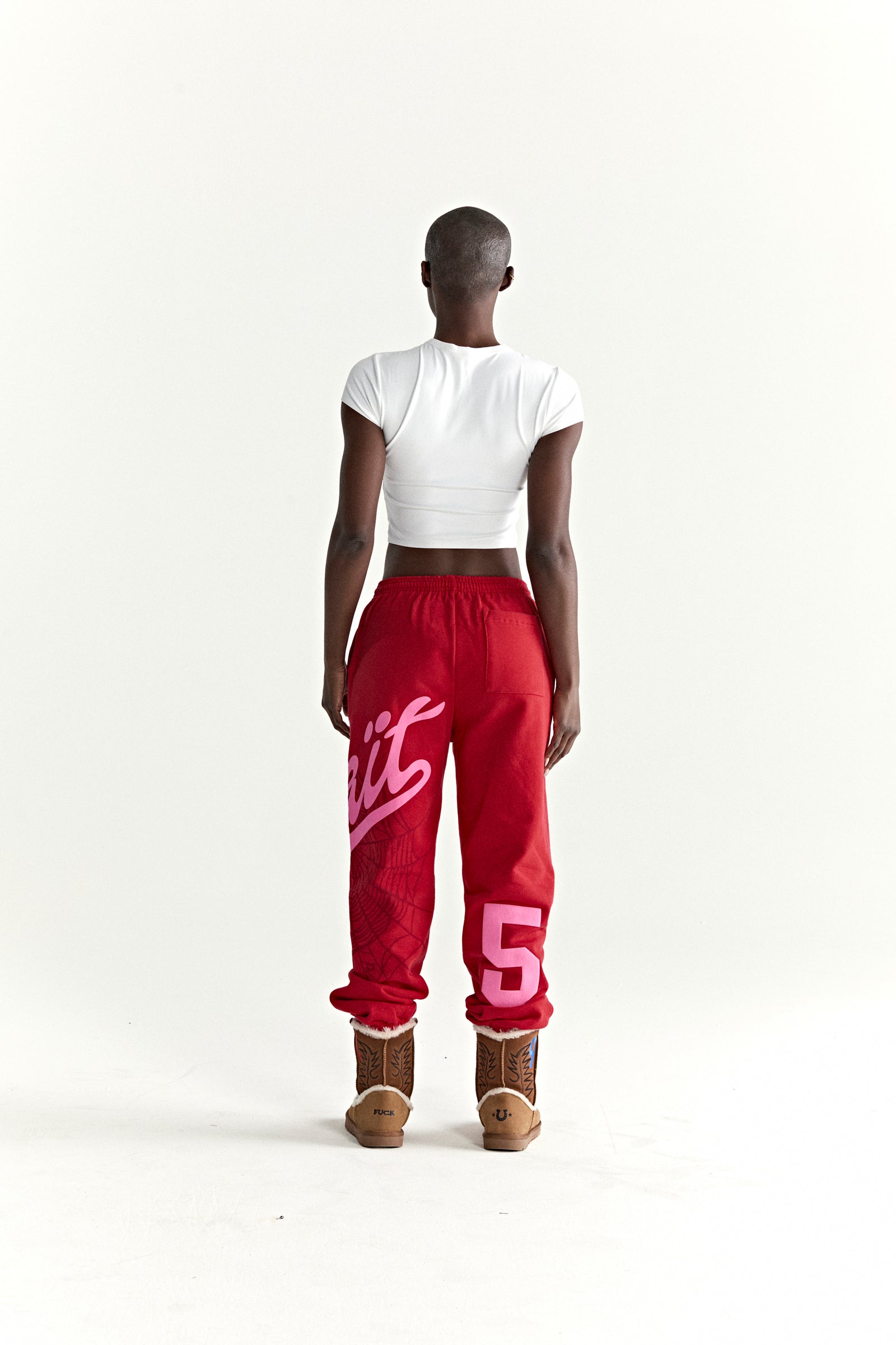 Red cotton fleece STADIUM SWEATPANT with pink 'Wait' script, web print, and '5' motif.
