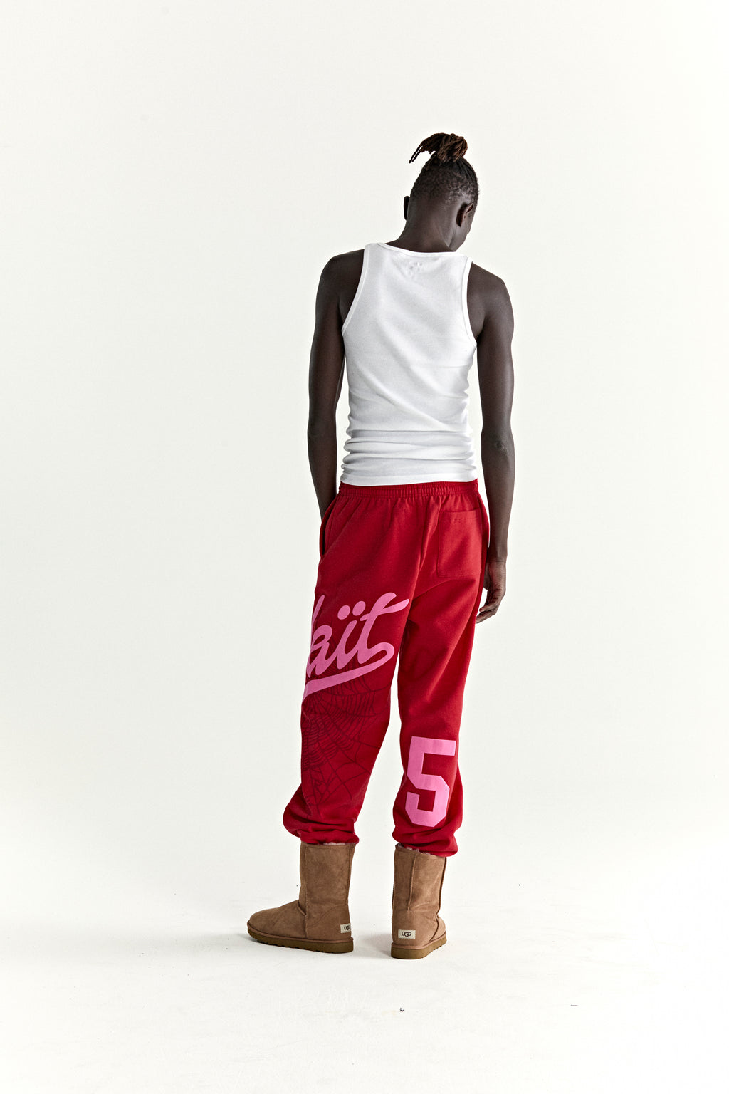 Red cotton fleece STADIUM SWEATPANT with pink 'Wait' script, web print, and '5' motif.