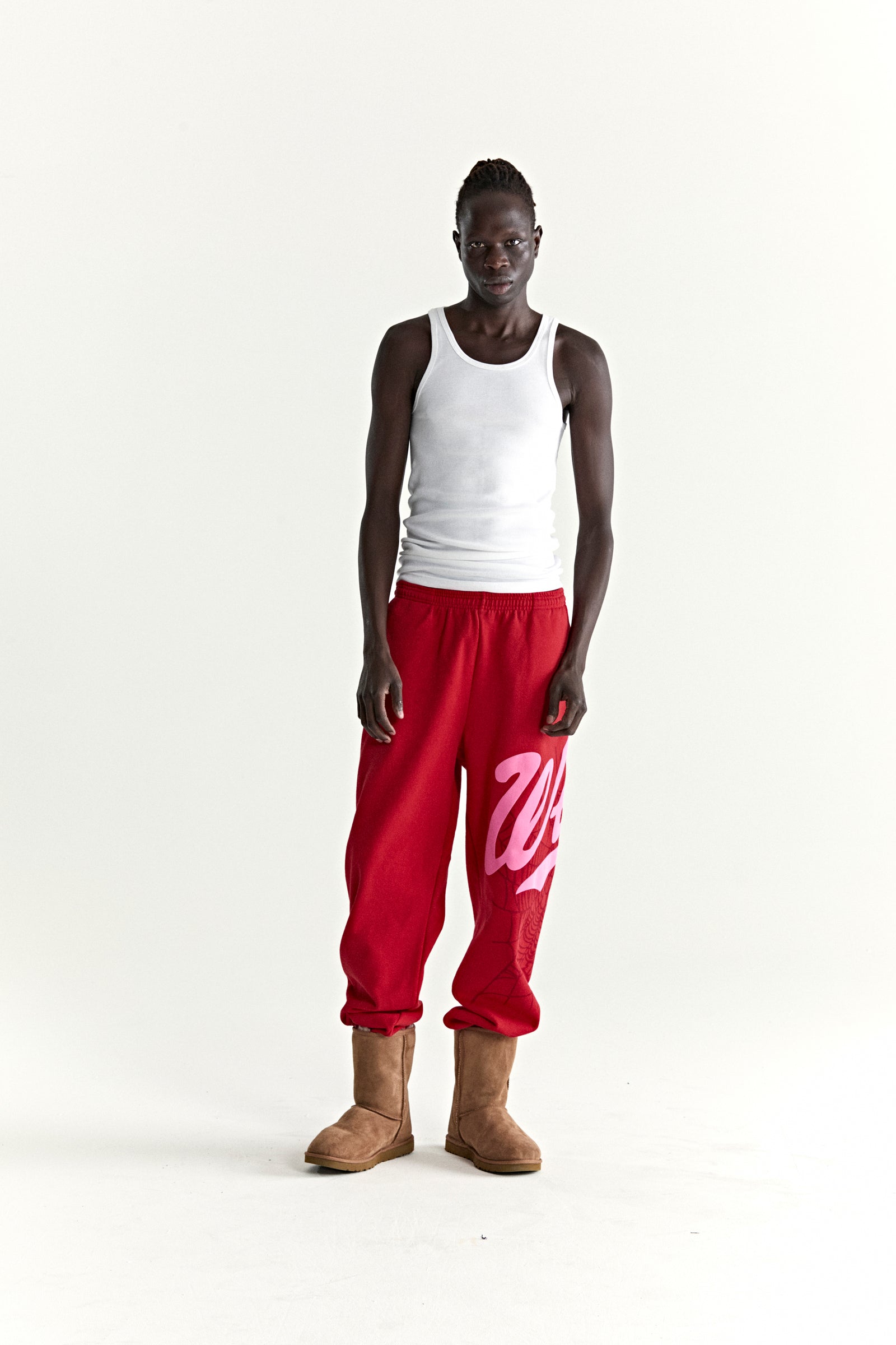 Red cotton fleece STADIUM SWEATPANT with pink 'Wait' script and web print, elasticized cuffs.