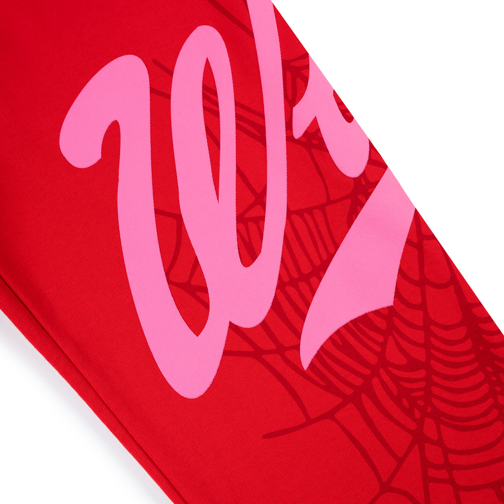 Red cotton fleece sweatpant with pink "Wait" script and spider web print.