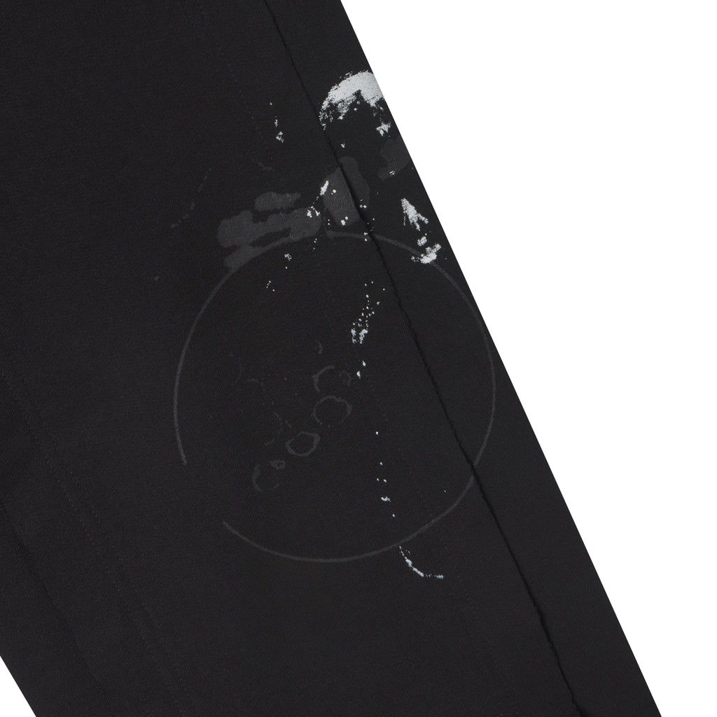 Black cotton fleece sweatpants featuring distressed white abstract graphic prints and subtle circular line designs.