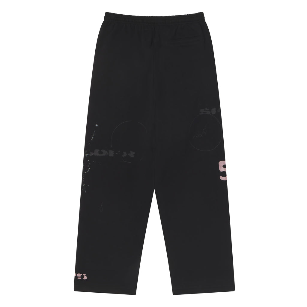 Black wide-leg cotton fleece sweatpants with distressed abstract graphic prints and an elasticized drawstring waistband.