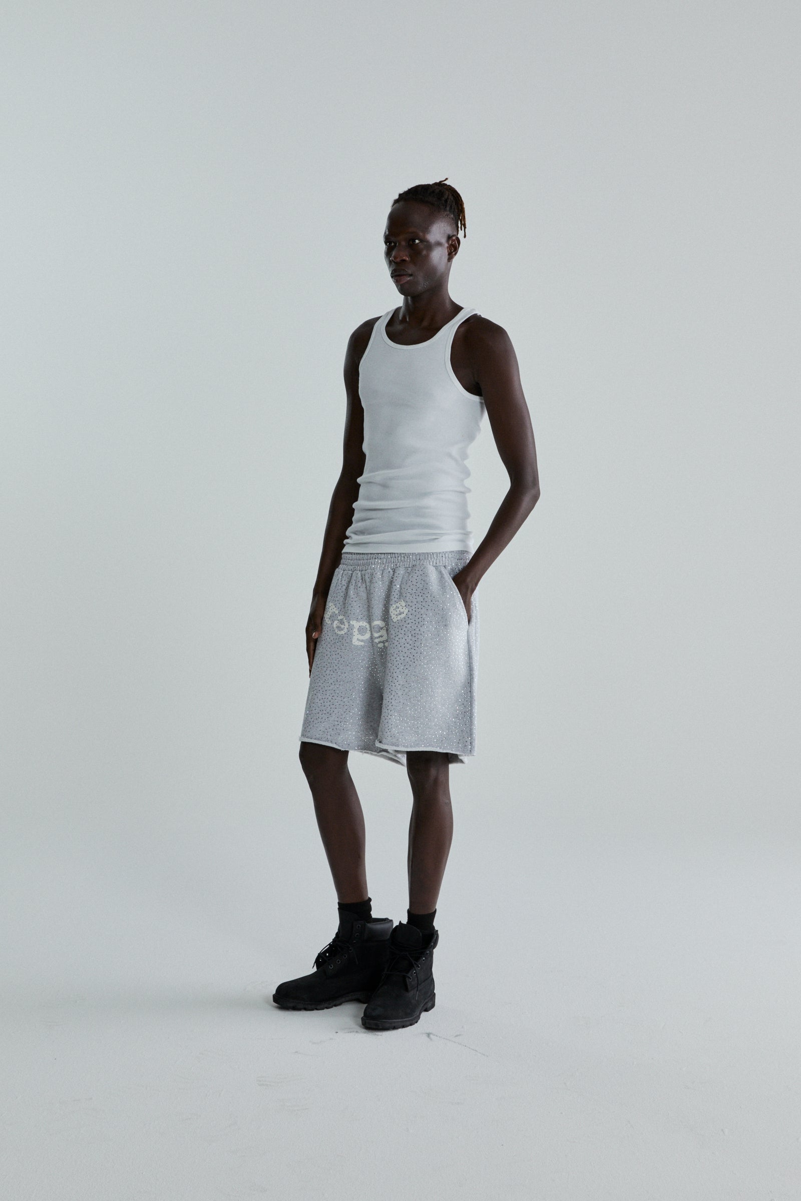 Gray VVS SWEATSHORT with tonal rhinestones and "SP5DER" text, worn by a model.