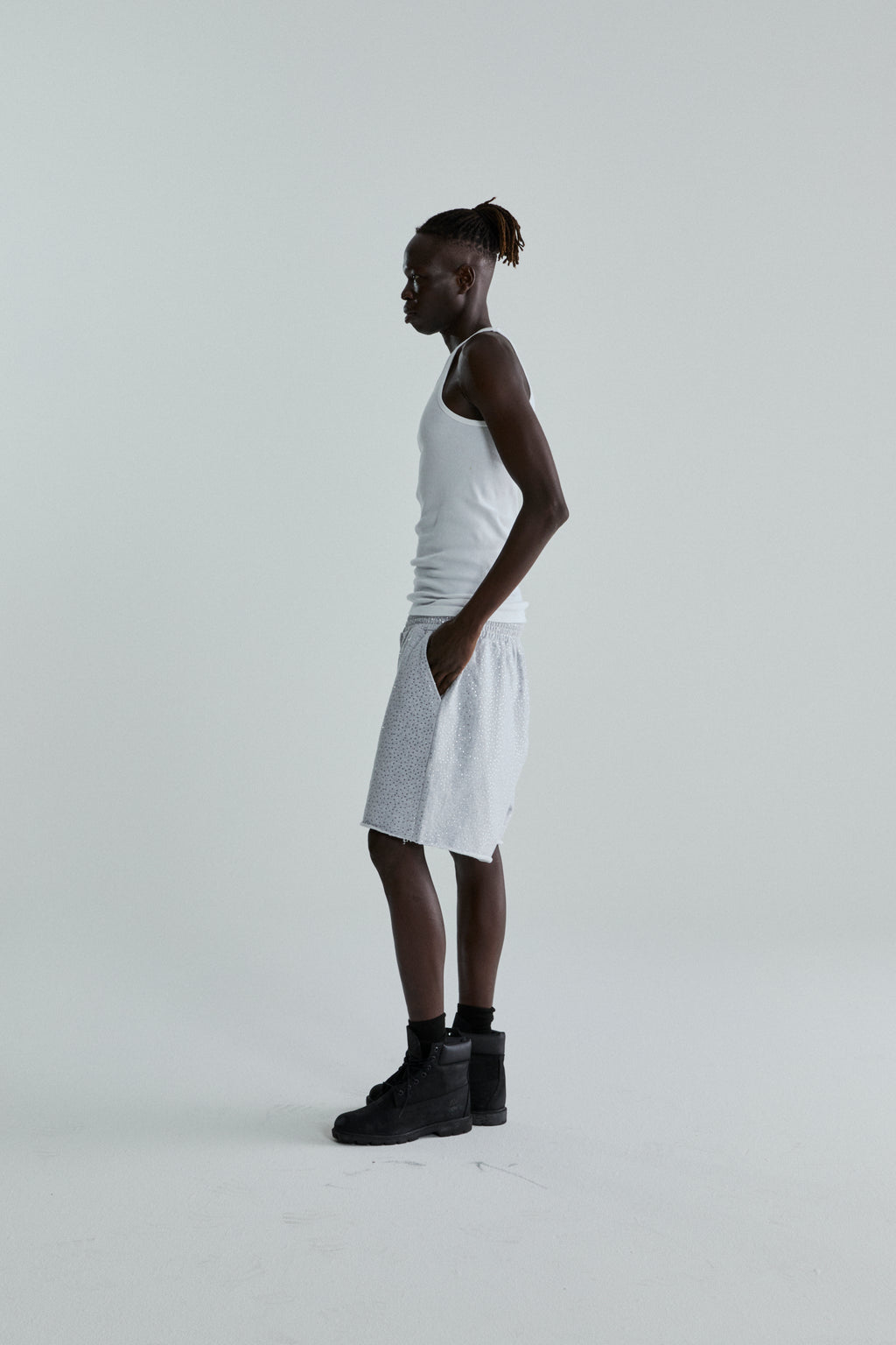 Model wearing VVS SWEATSHORT: light grey 13oz cotton fleece shorts with tonal rhinestone application and raw hem.