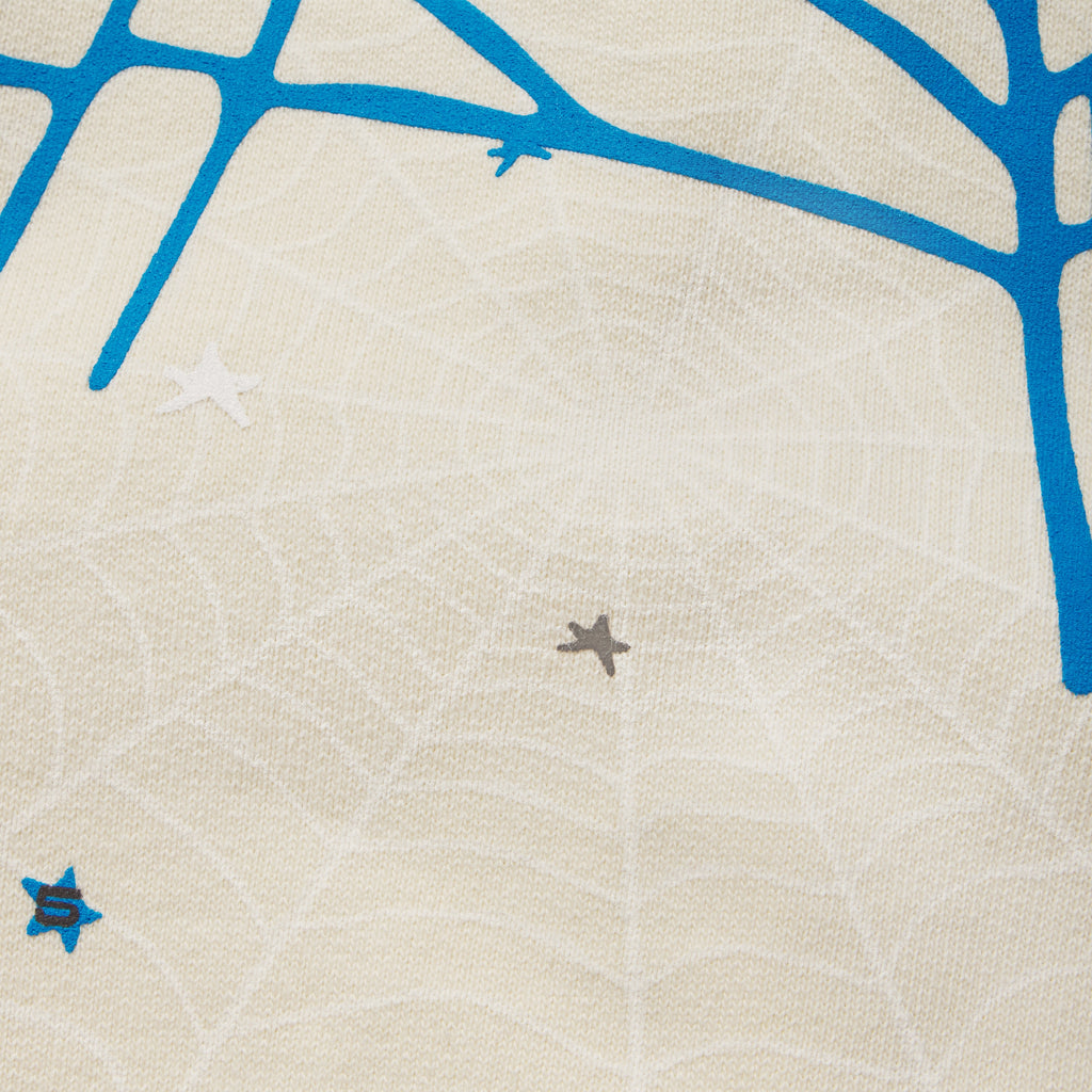 Cream 13oz cotton fleece sweatpants featuring a blue SP5DER web graphic and scattered star print design.