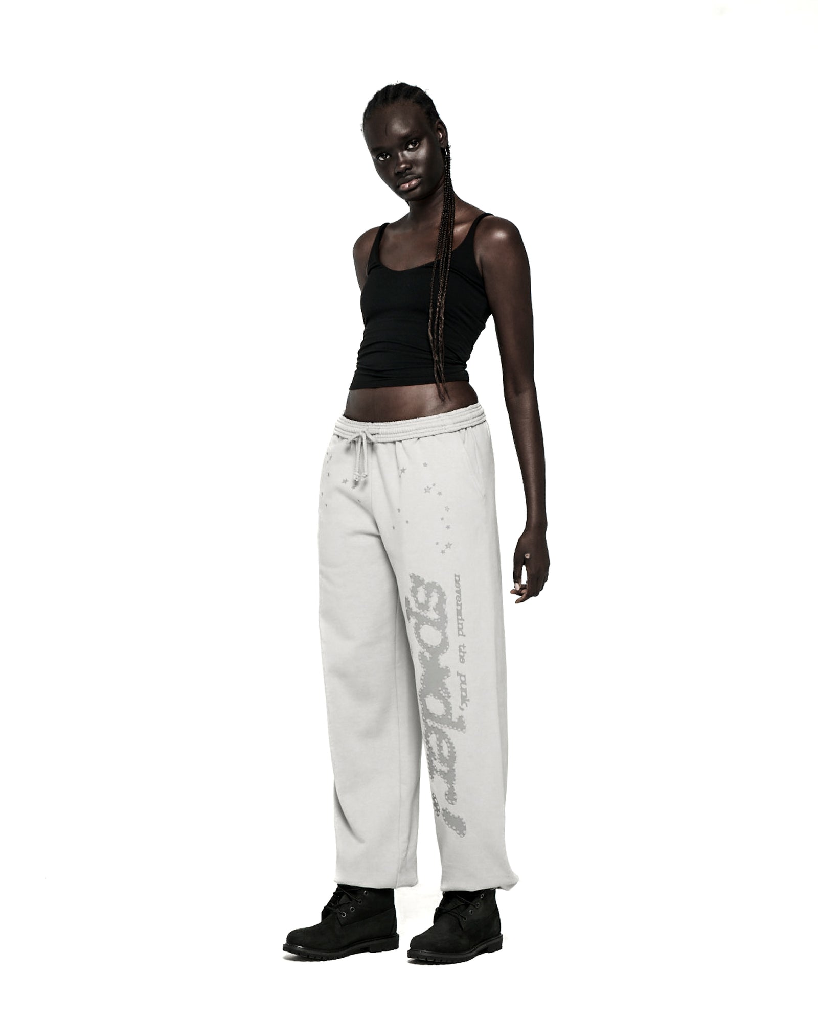 Light grey TONAL PUNK V2 SWEATPANT with "P*NK SP5DER" text and stars, worn by a model.