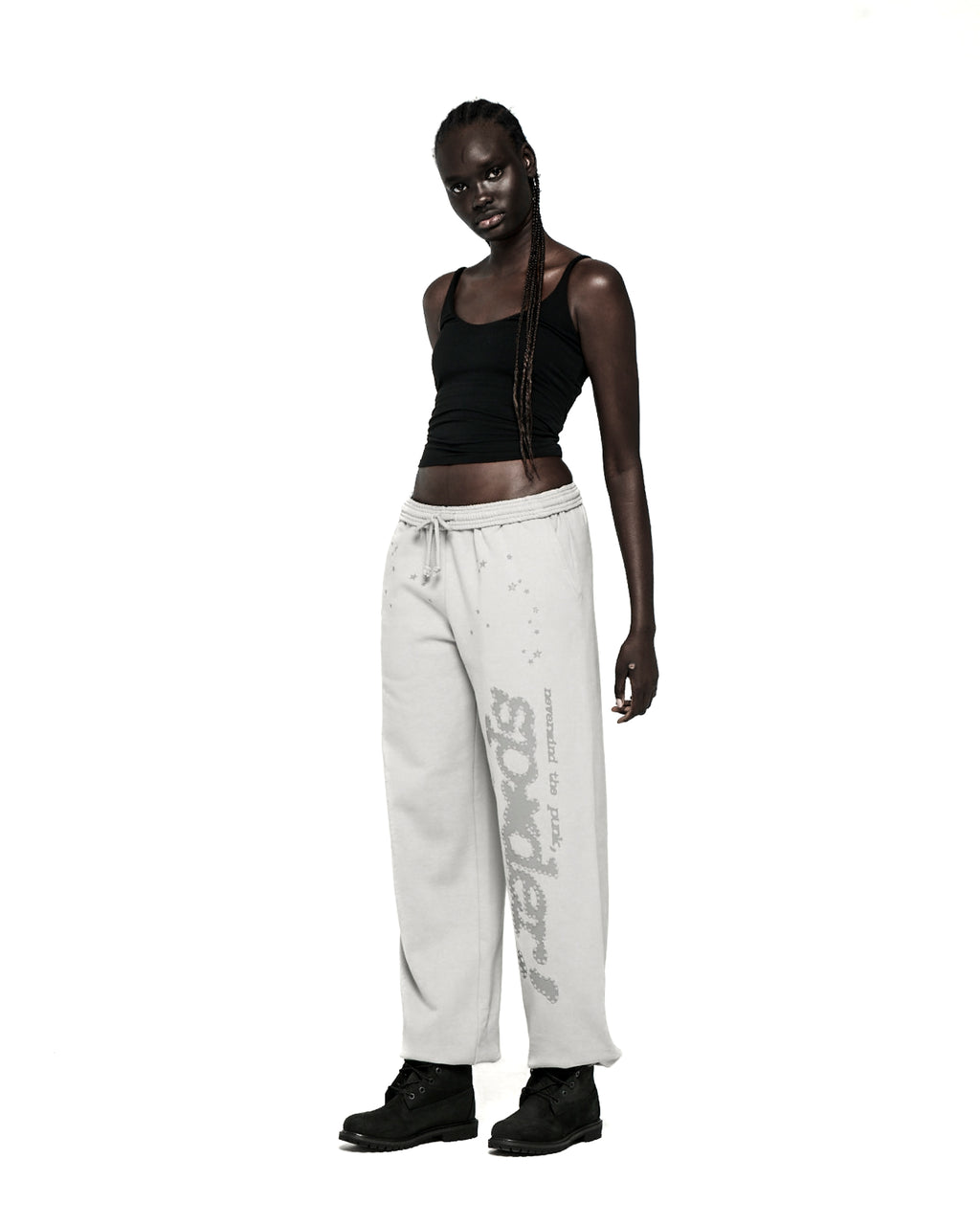 Light grey TONAL PUNK V2 SWEATPANT with "P*NK SP5DER" text and stars, worn by a model.