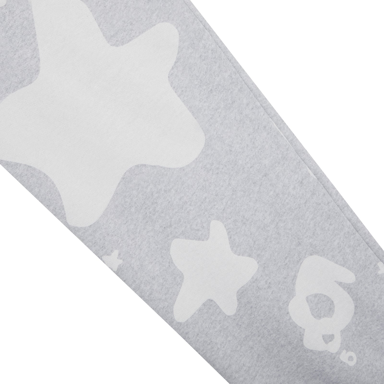 Close-up of gray cotton fleece BELUGA V2 SWEATPANT with white puff print star and beluga designs.