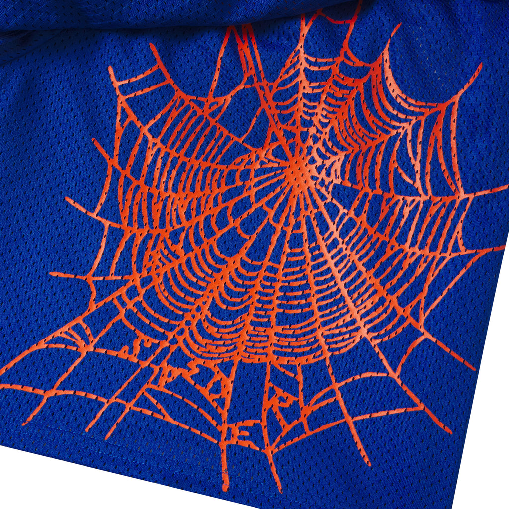 Blue breathable mesh shorts featuring a bold orange spider web graphic print on the front layer.