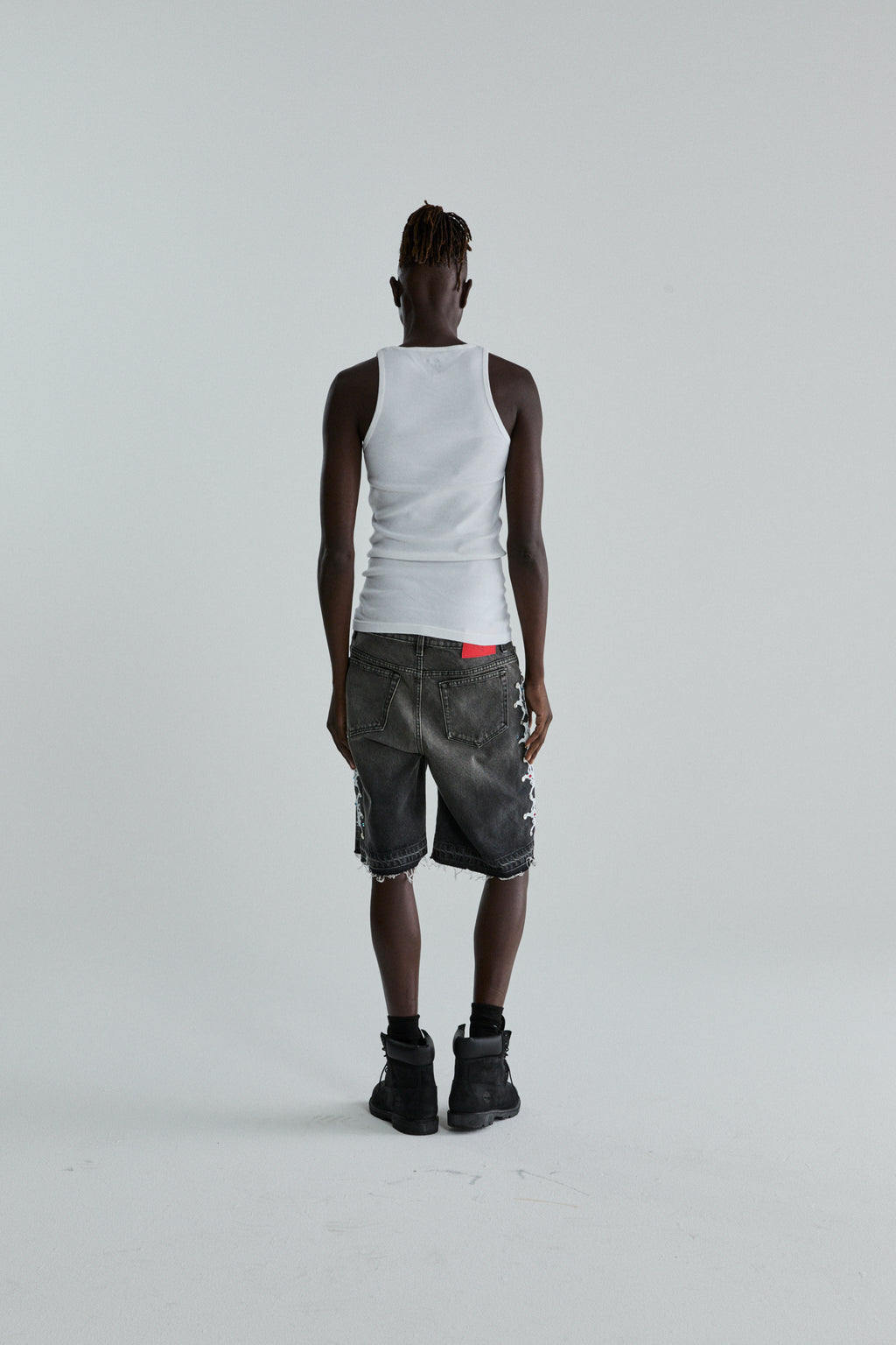 BLACK WASH WEB STONE DENIM SHORTS ON MODEL