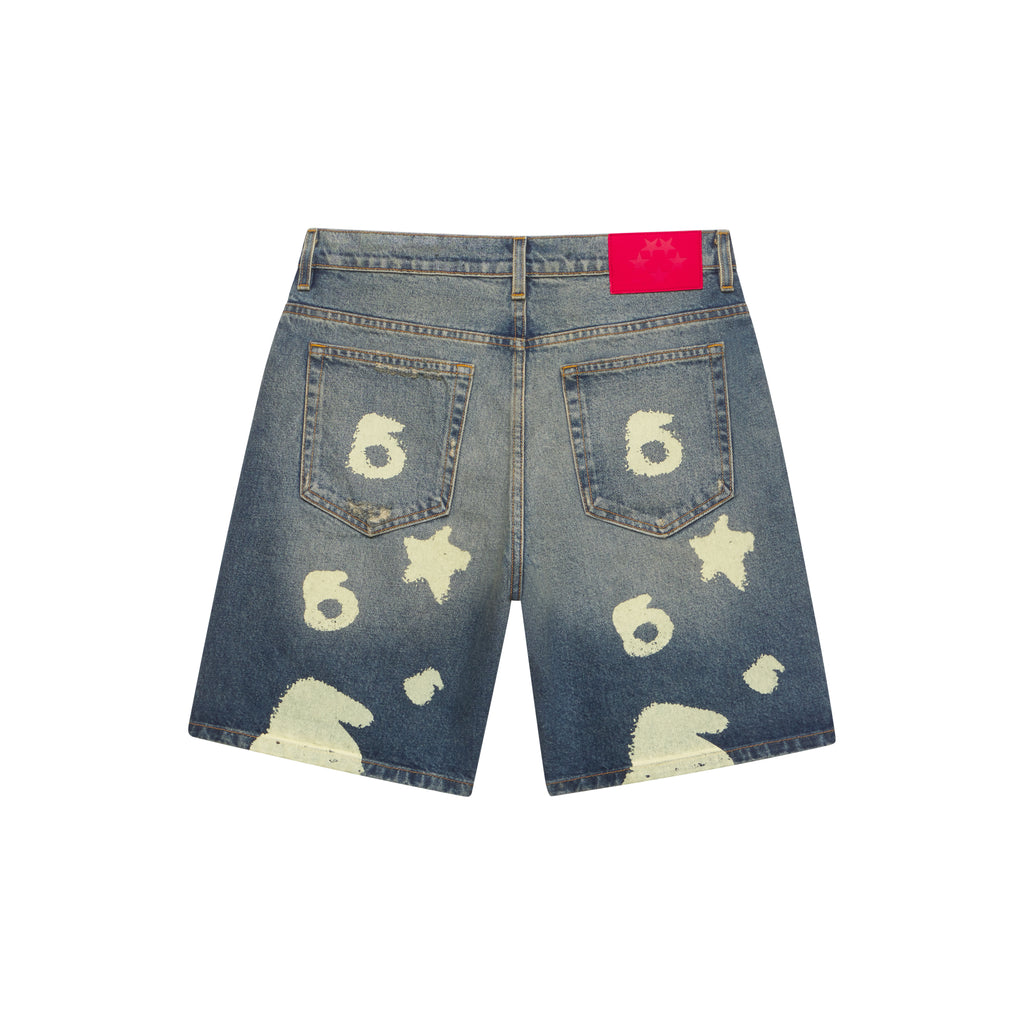 Blue denim shorts with white Beluga print, five-pocket styling, and a bright pink leather patch.