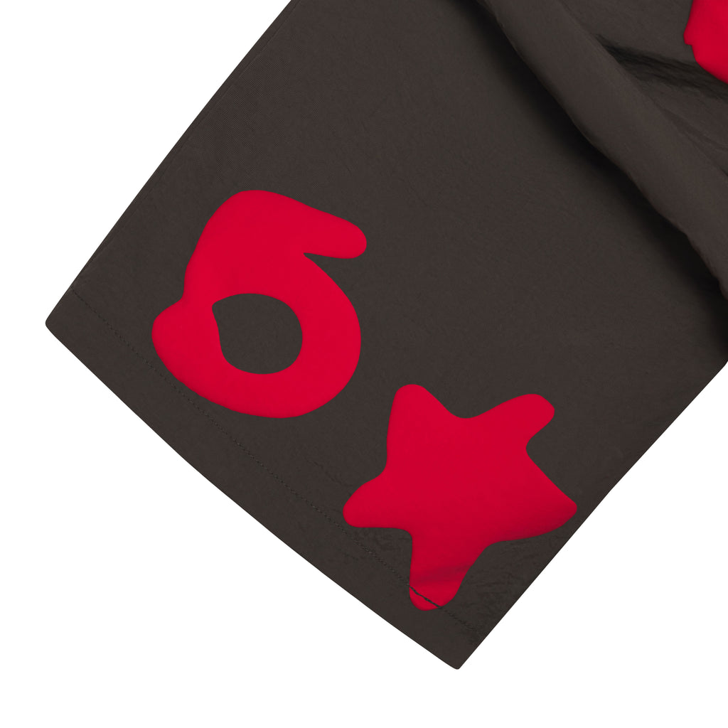 Beluga Double Layer Short: Dark gray water-repellent nylon shorts with red "6" and star prints.