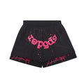 Front of Black water-repellent nylon shorts with pink "Sp5der" text, star print, and elastic waistband.