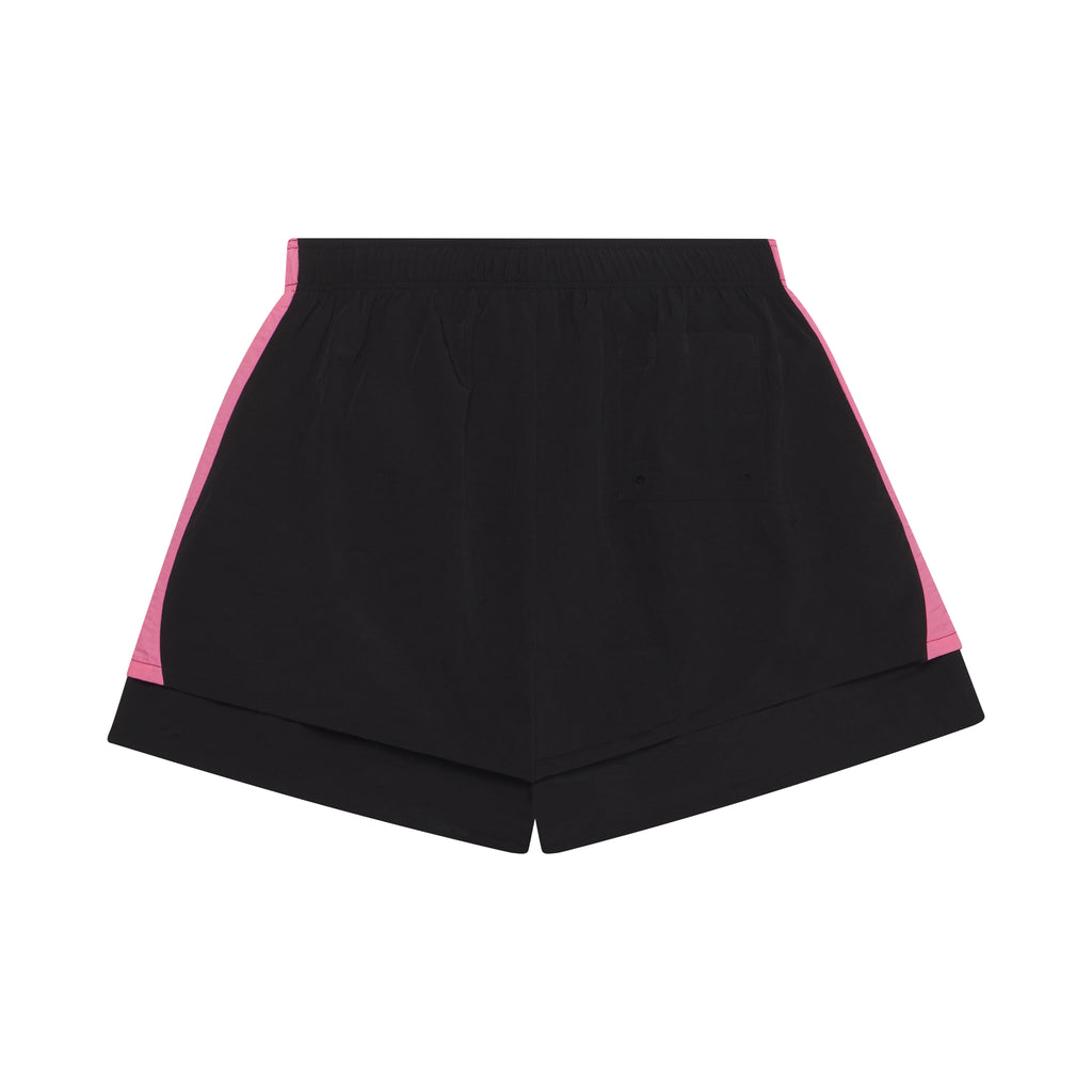 Black double-layer soccer shorts with pink wide side stripes, elastic waistband, and patch back pocket.