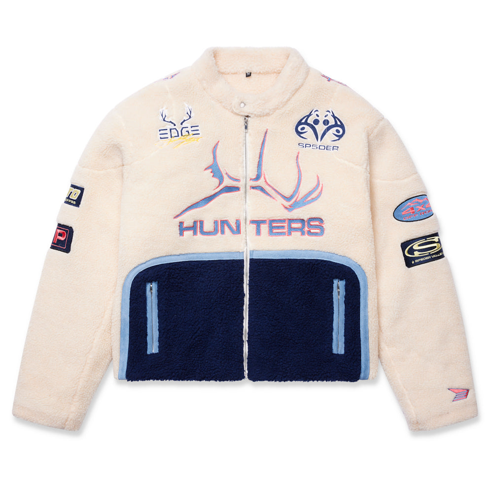 Cream sherpa moto jacket with navy bottom panel, custom SP5DER patches, and "HUNTERS" embroidery.