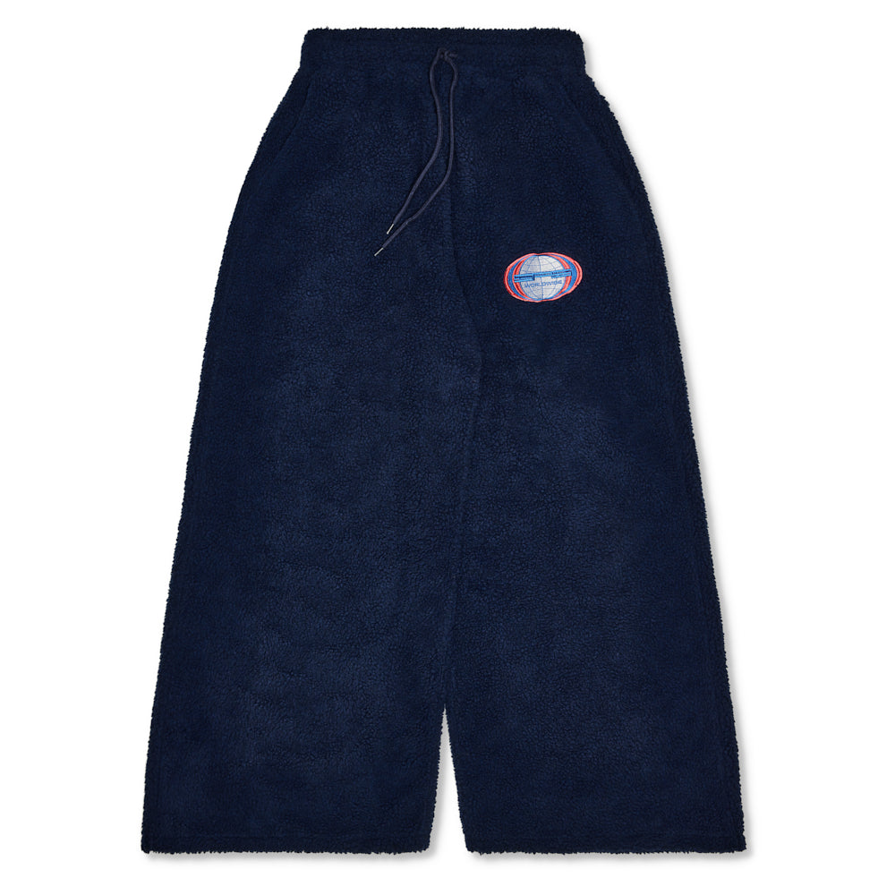 Navy sherpa wide leg pants with drawstring waist and "Worldwide" globe patch.