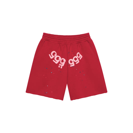Red 13oz cotton fleece shorts with pink angel number print on crotch, scattered stars, drawcord, and raw hem.