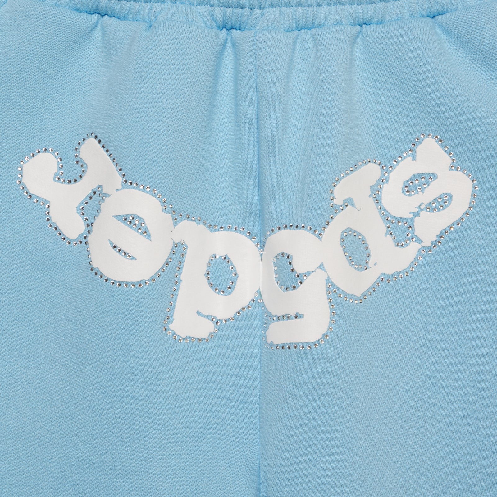 Light blue cotton fleece sweatshorts with "SP5DER" text in white and silver rhinestones on the crotch.