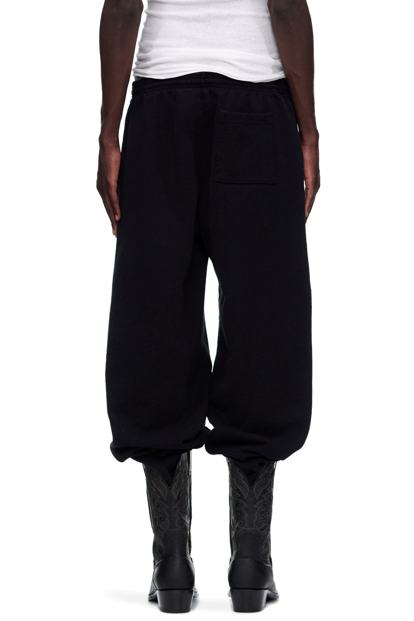 Black P*NK V2 Sweatpants, 23oz fleece, with SP5DER motif and star prints, worn by male model.