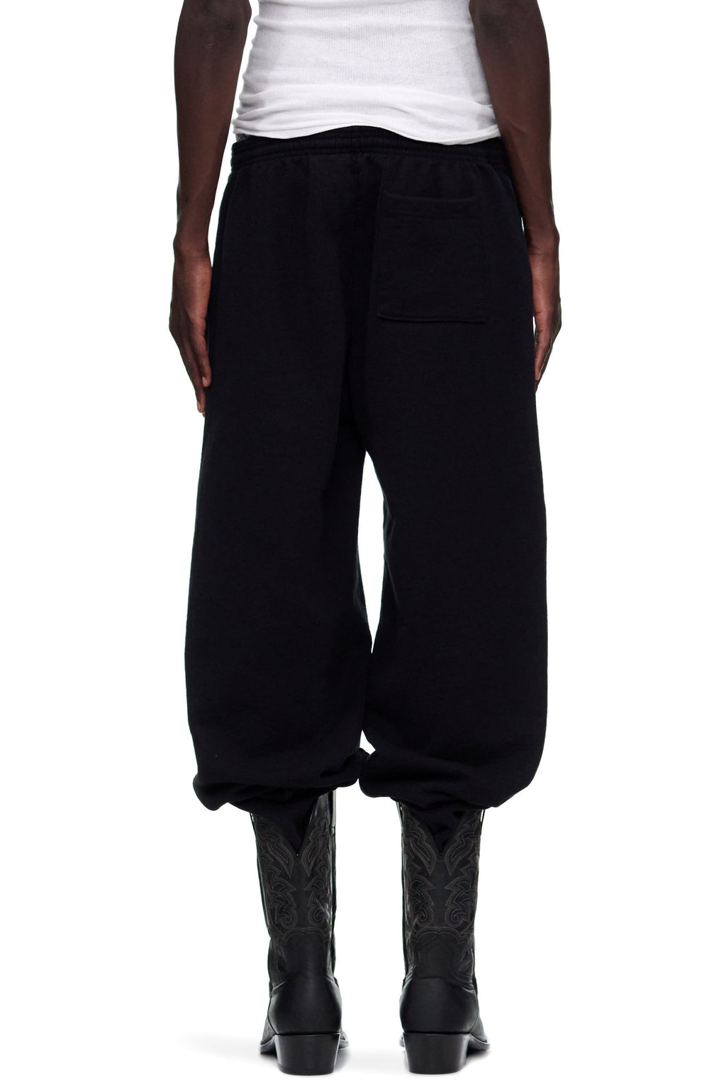Black P*NK V2 Sweatpants, 23oz fleece, with SP5DER motif and star prints, worn by male model.