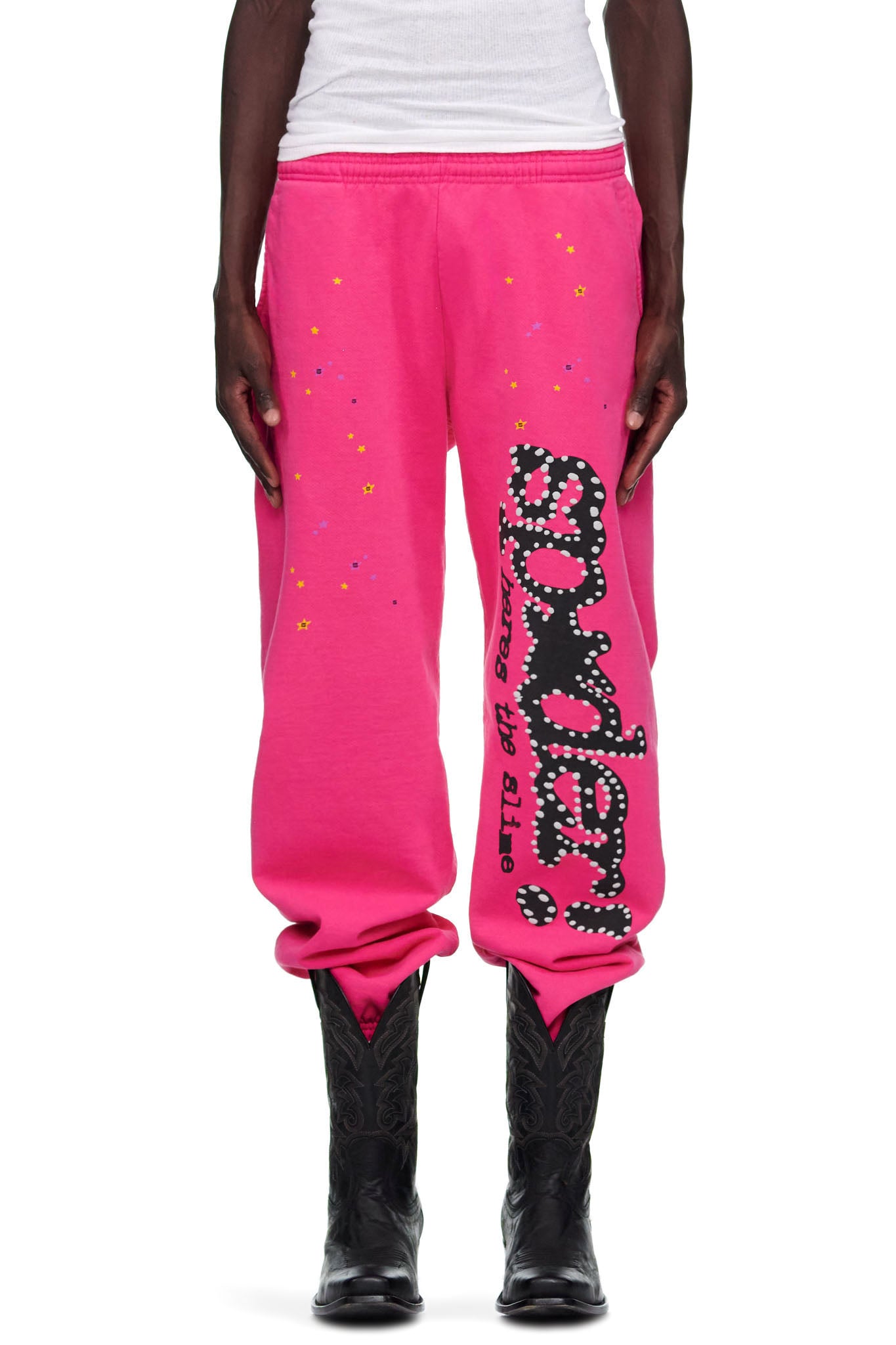 Pink P*NK V2 sweatpants with black "SP5DER" puff print, discharge print, and star motifs.