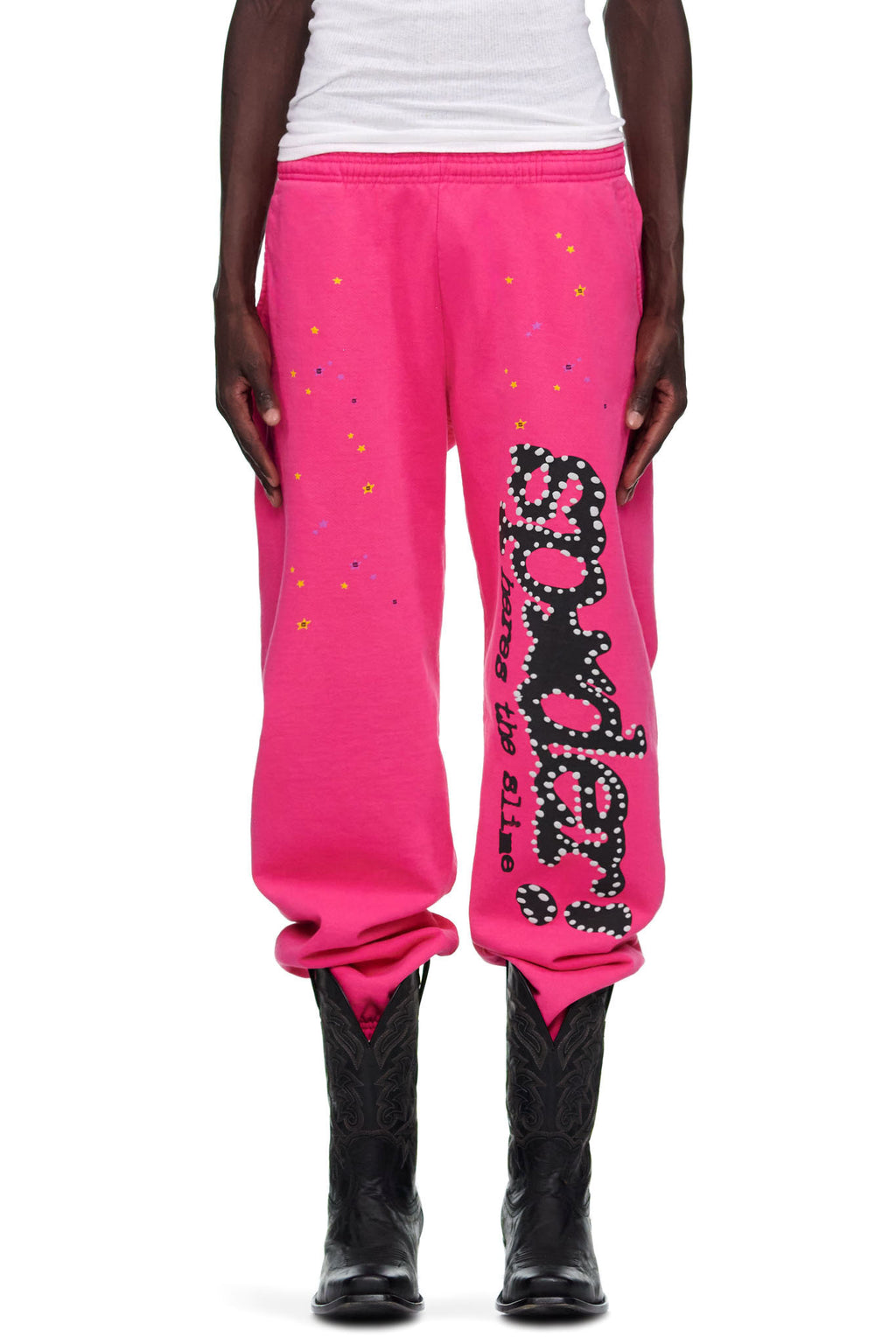 Pink P*NK V2 sweatpants with black "SP5DER" puff print, discharge print, and star motifs.