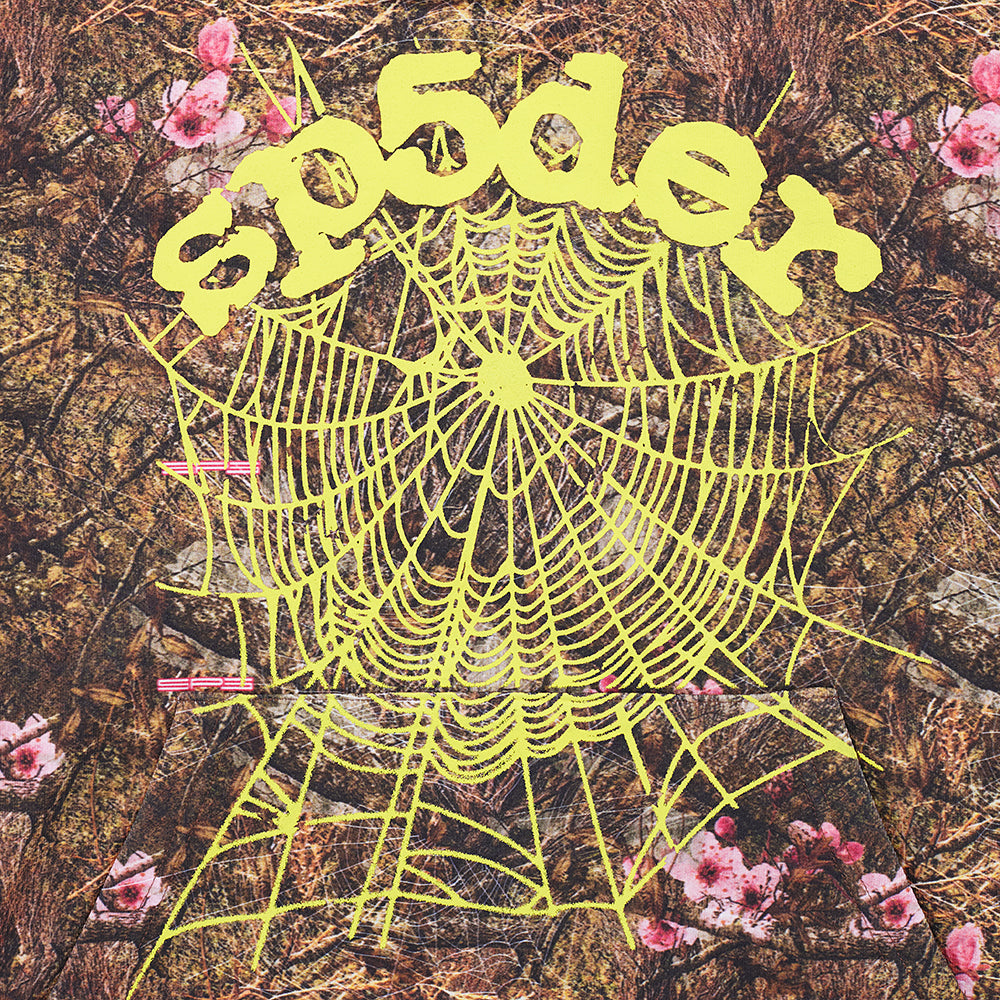 Real Tree OG Web Hoodie: brown camo fleece with yellow "SP5DER" text and spider web puff print.