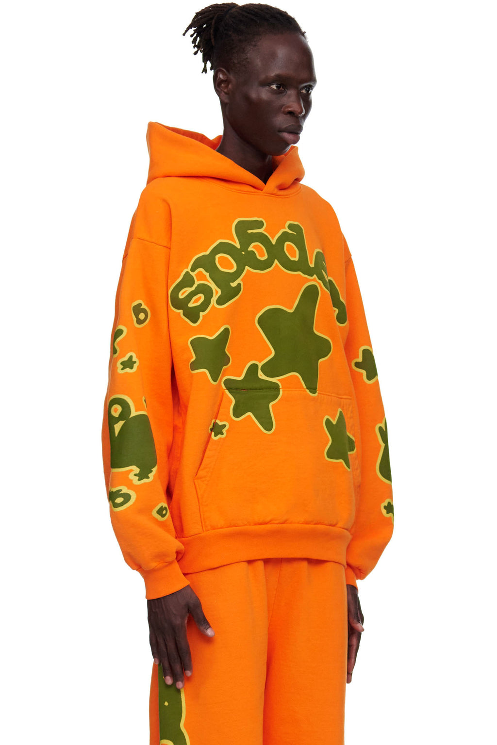 Orange BELUGA HOODIE with green 'SP5DER' and star puff print, worn by a male model.
