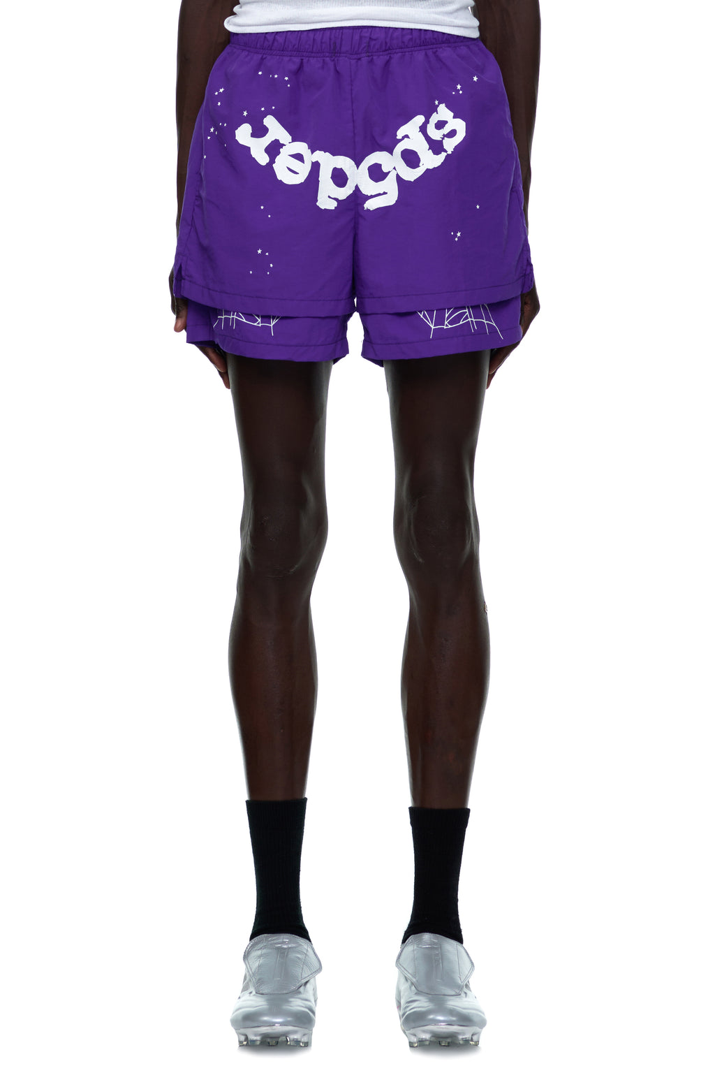 Purple nylon shorts with white "sp5der" text, web print, and paint splatter design.