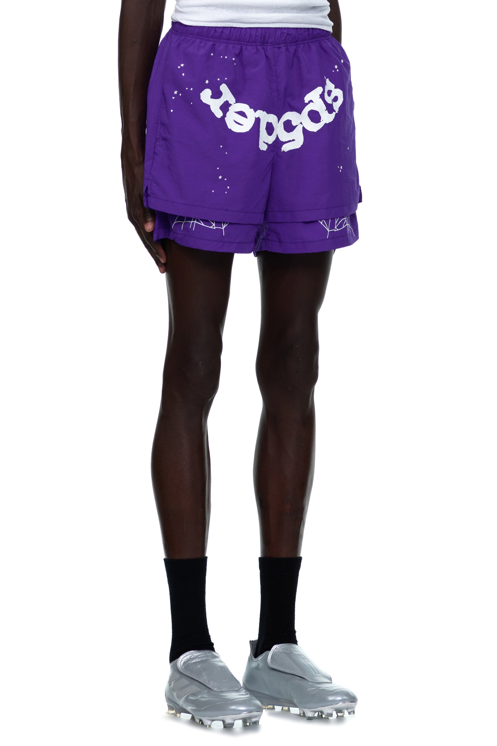 Purple nylon shorts with white "SP5DER" text, web print, and high-low double layer design.