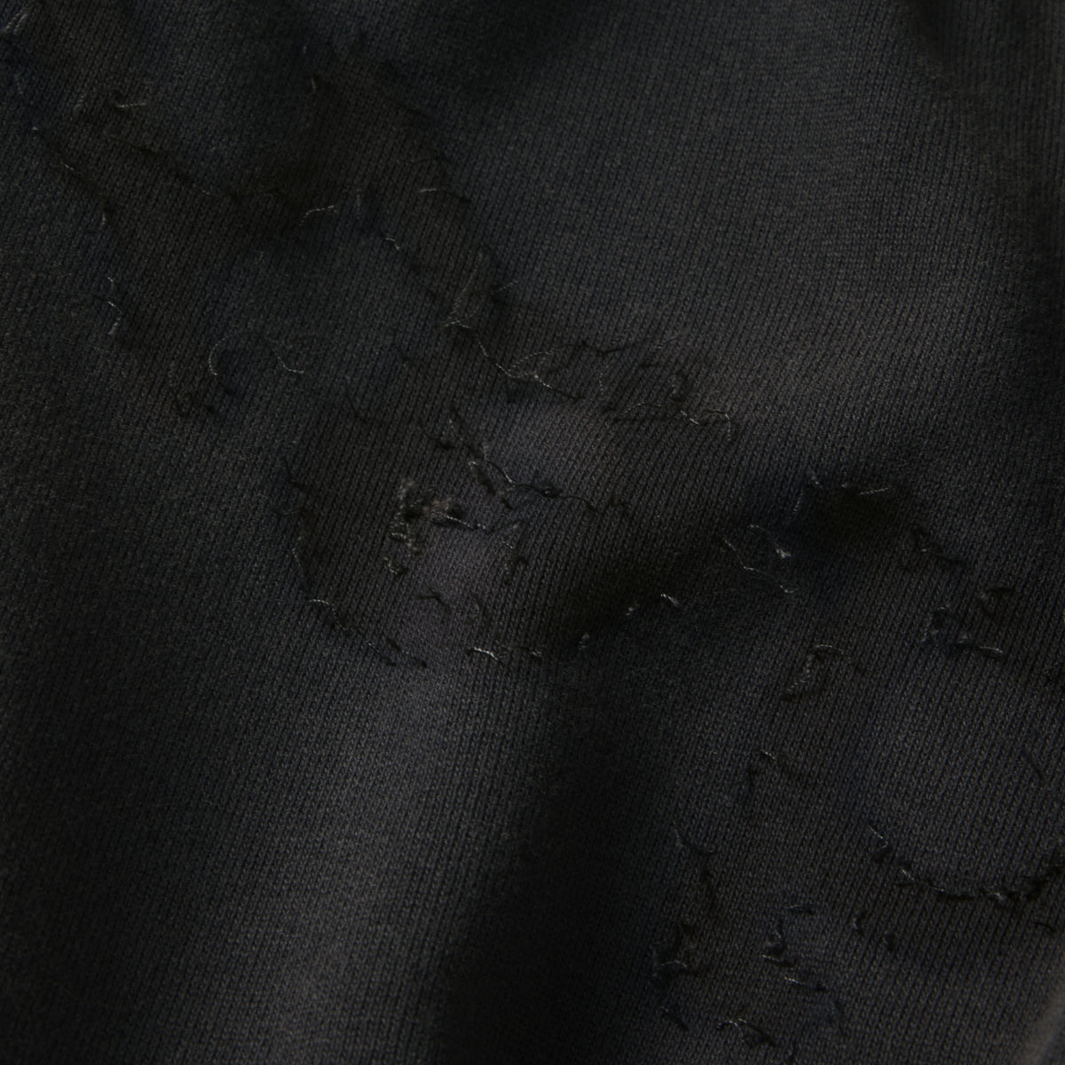 Black 100% cotton fleece sweatpants featuring a distressed SP5DER graphic print and star design detail.