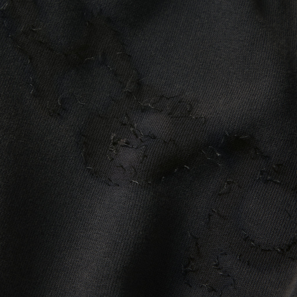 Black 100% cotton fleece sweatpants featuring a distressed SP5DER graphic print and star design detail.