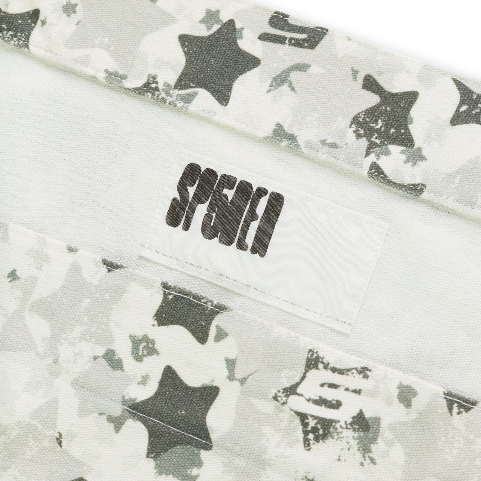Star Camo Beluga AOP Tote, 8oz brushed twill with white, grey, and black star camo print and "SP5DER" label.