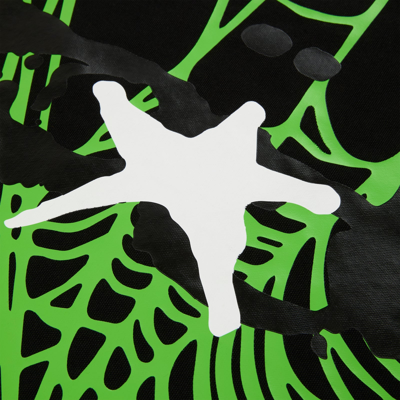 Close-up of a black 8oz brushed twill HEAVY WEB TOTE with a vibrant green and white star graphic print.