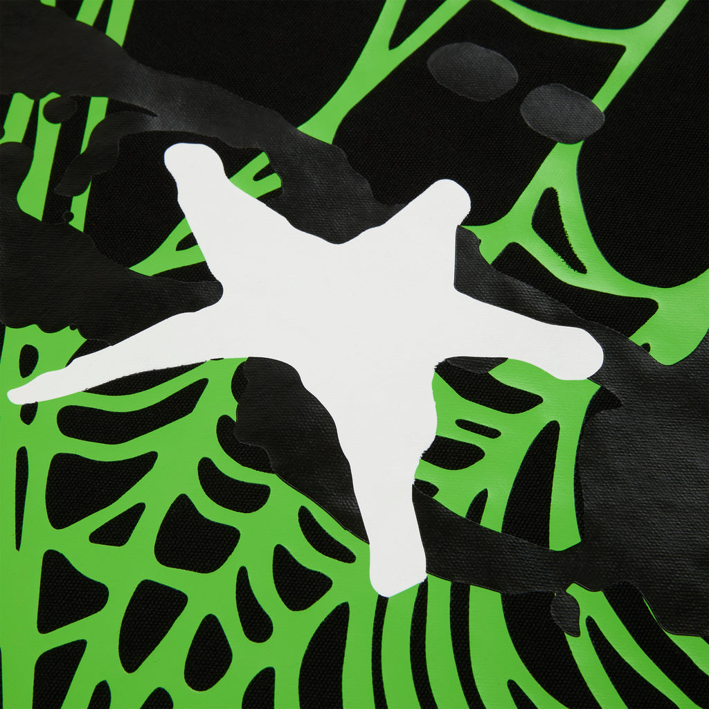Close-up of a black 8oz brushed twill HEAVY WEB TOTE with a vibrant green and white star graphic print.