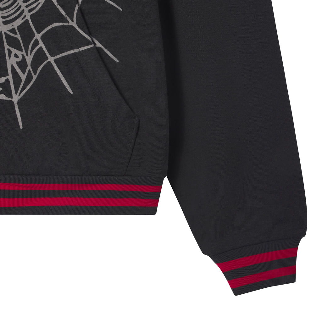 Black 13oz cotton fleece zip hoodie featuring a grey web graphic print and red-striped ribbed cuffs and hem.